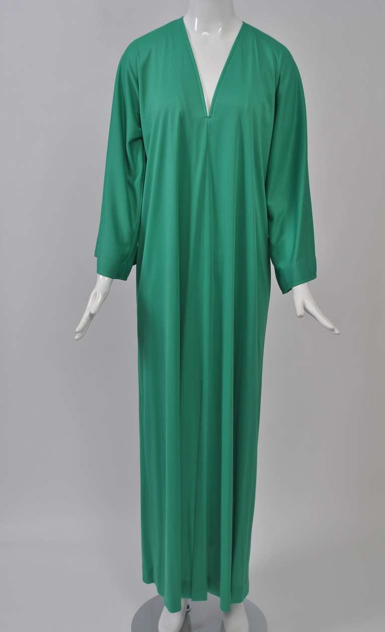 V-neck caftan in bright green polyester with center slit and wide sleeves by Halston IV label, manufactured by Dorian. One size fits all.