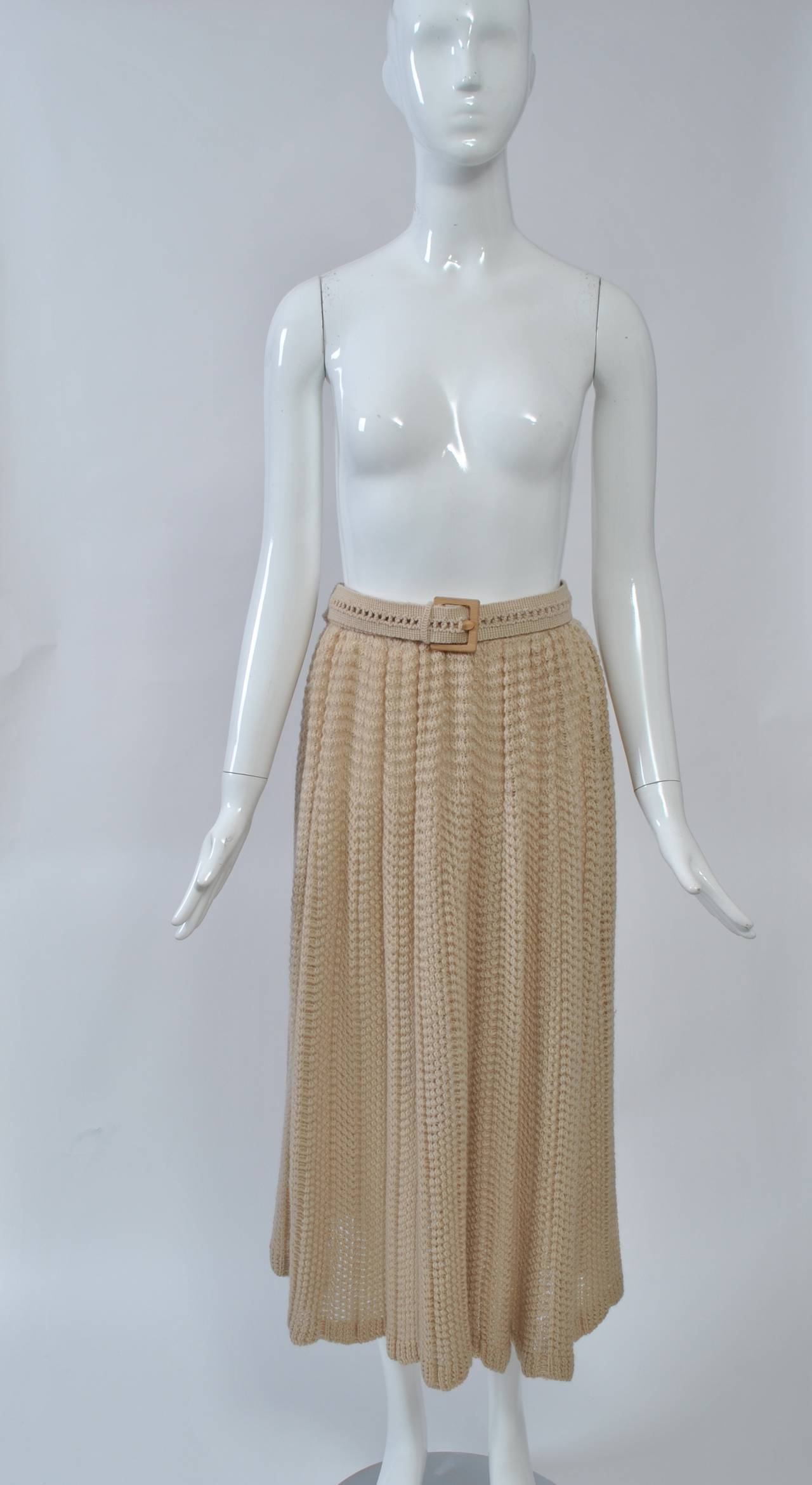 Missoni 1970s beige openwork knit skirt falls softly to mid calf and has a matching knit belt with wooden buckle. The knit runs horizontally across the hip area and vertically below. The waist is elasticized so can expand to fit a 32