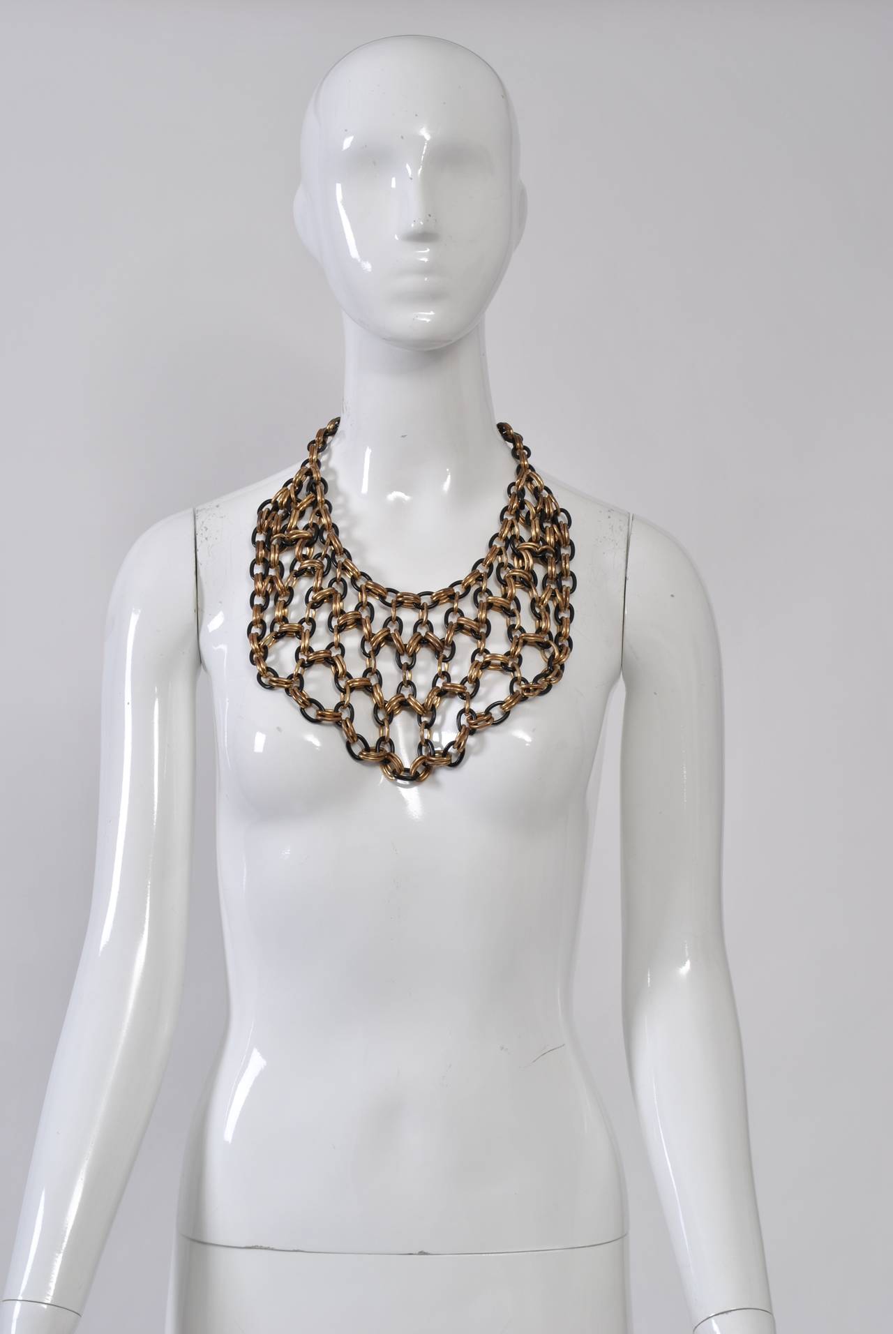 1980s bib necklace composed of alternating single black and double dark gold links. The necklace has a 5