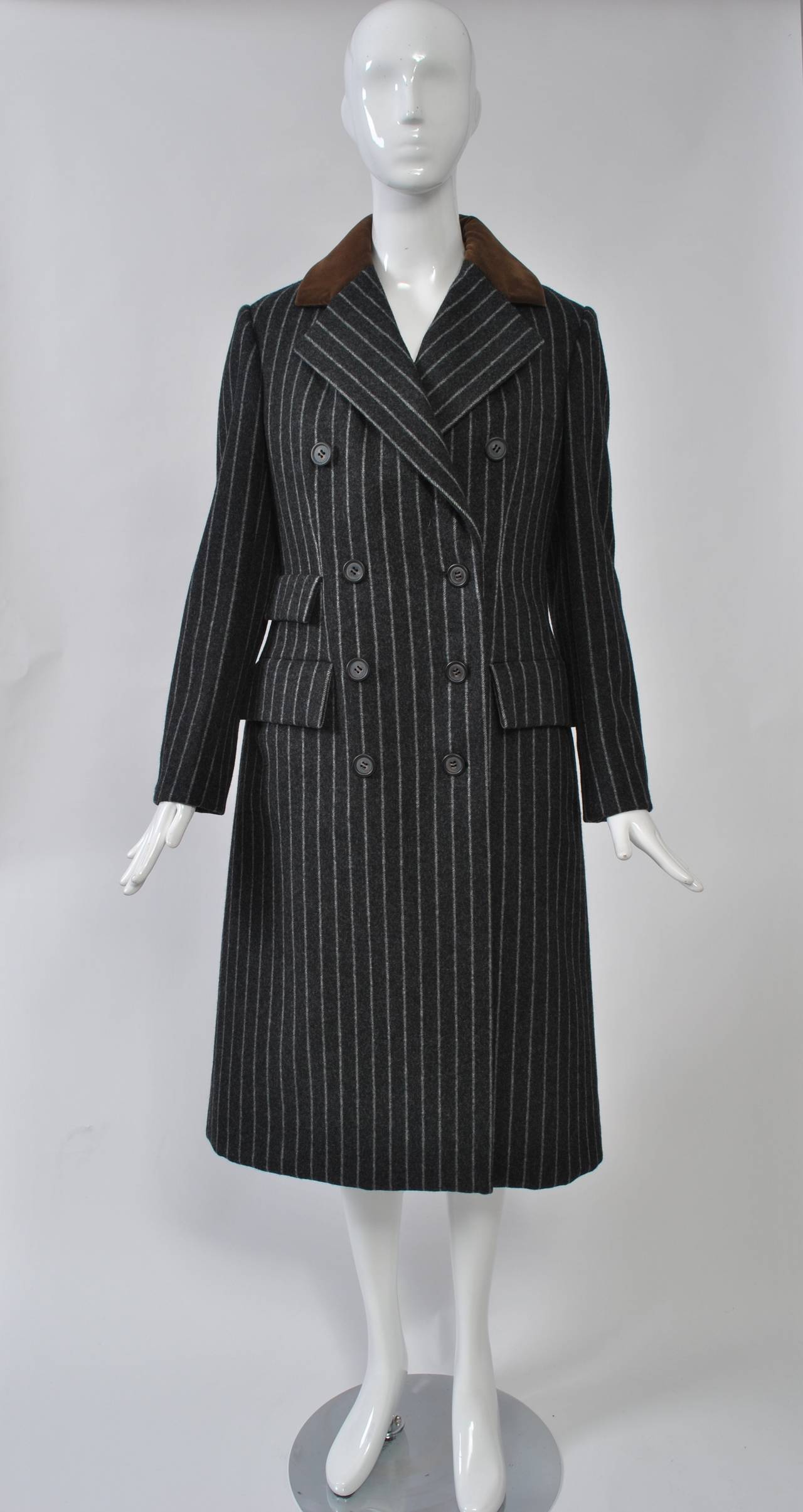 Beautifully tailored, menswear-inspired 1970s outfit from master Bill Blass, consisting of coat, skirt, and vest. The coat and skirt are constructed of a heavy wool, the coat accented with cognac velvet for the back half of the wide notched lapels.