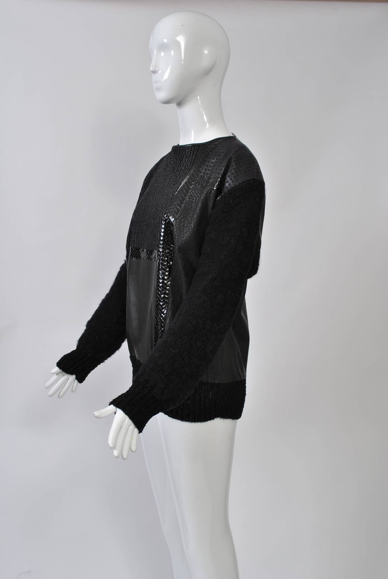 Great top from the 1980s crafted of smooth black leather, p´eatterned black leather, and black snakeskin in a patchwork pattern mixed with black wool bouclé. Back zipper. Unlined. No label.