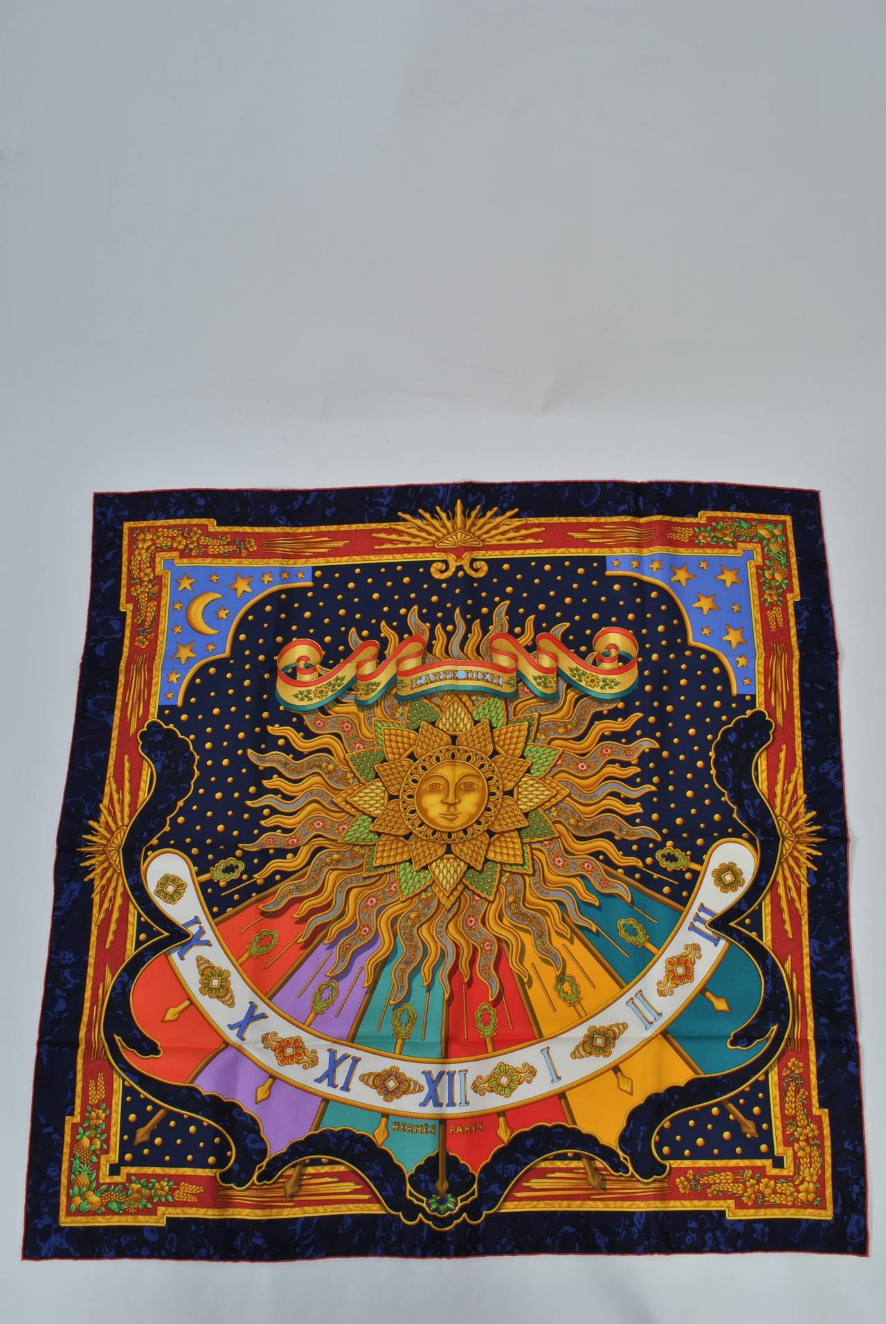 Jewel tone, vibrant Hermès large silk scarf centered a sun. Issued 1994. In original box. Unused.