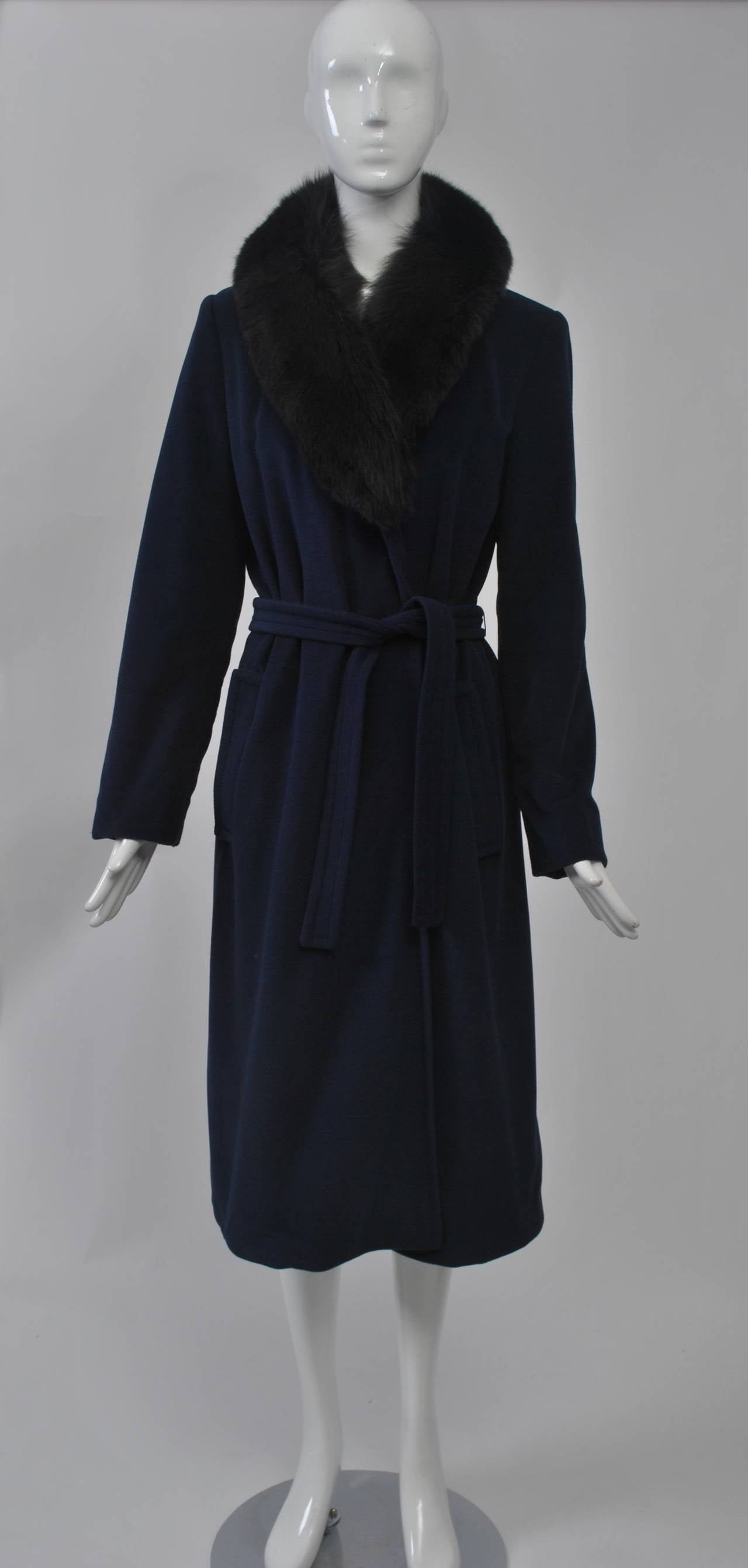 Classic wrap coat from Bonnie Cashin in a soft navy wool features a fox shawl collar and patch pockets.