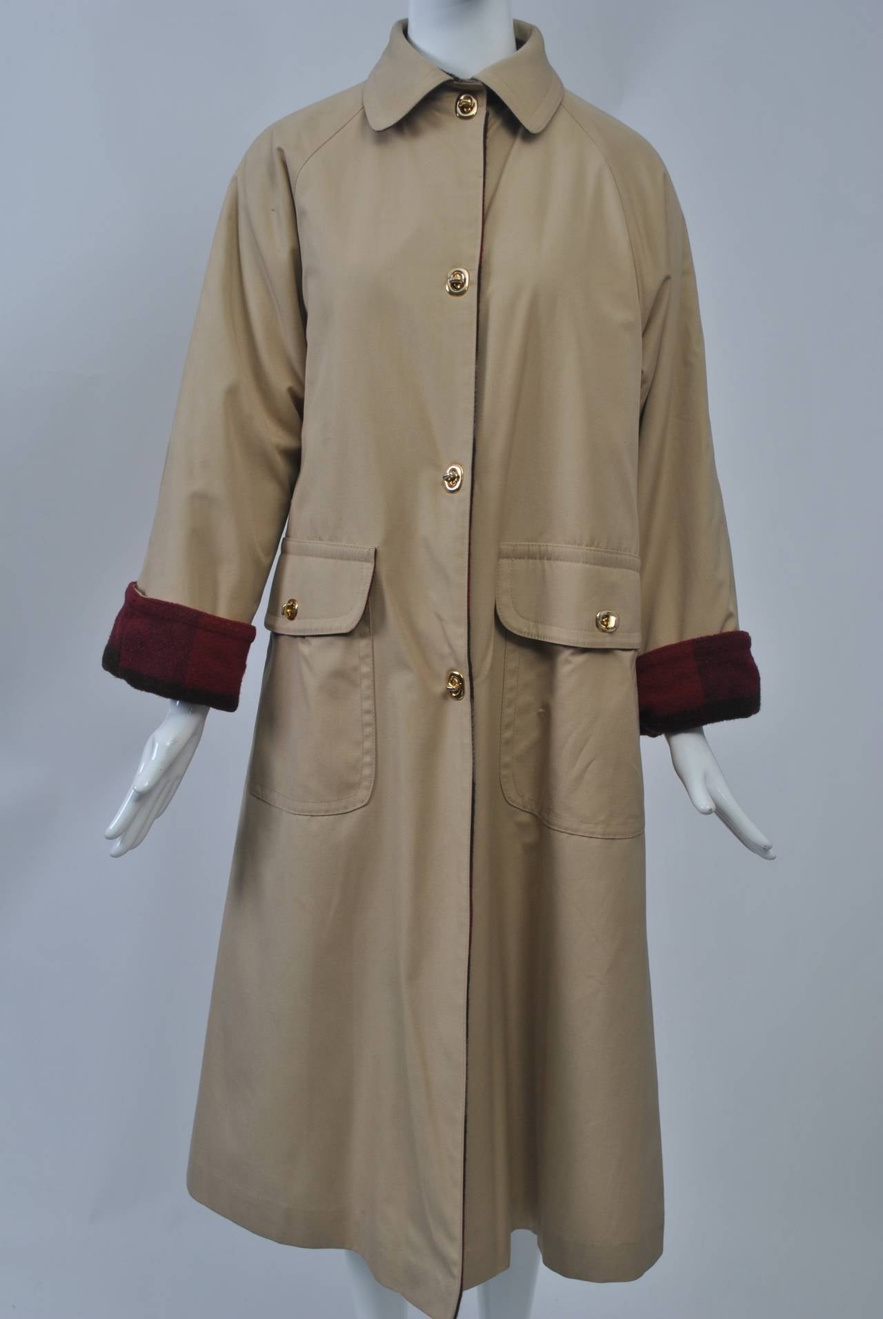 Bonnie Cashin tan poplin swing-style coat featuring her signature toggle closures and large patch pockets. Lined in plaid wool for warmth.