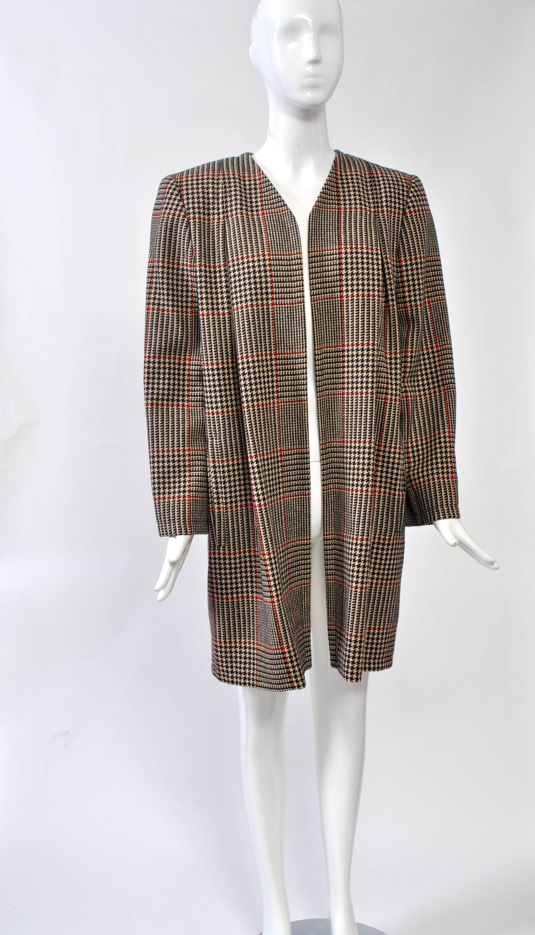 1980s brown glen plaid coat by Valentino featuring a collarless, open front, shoulder pads, soft shoulder pleats in front, and an inverted pleat in back. 