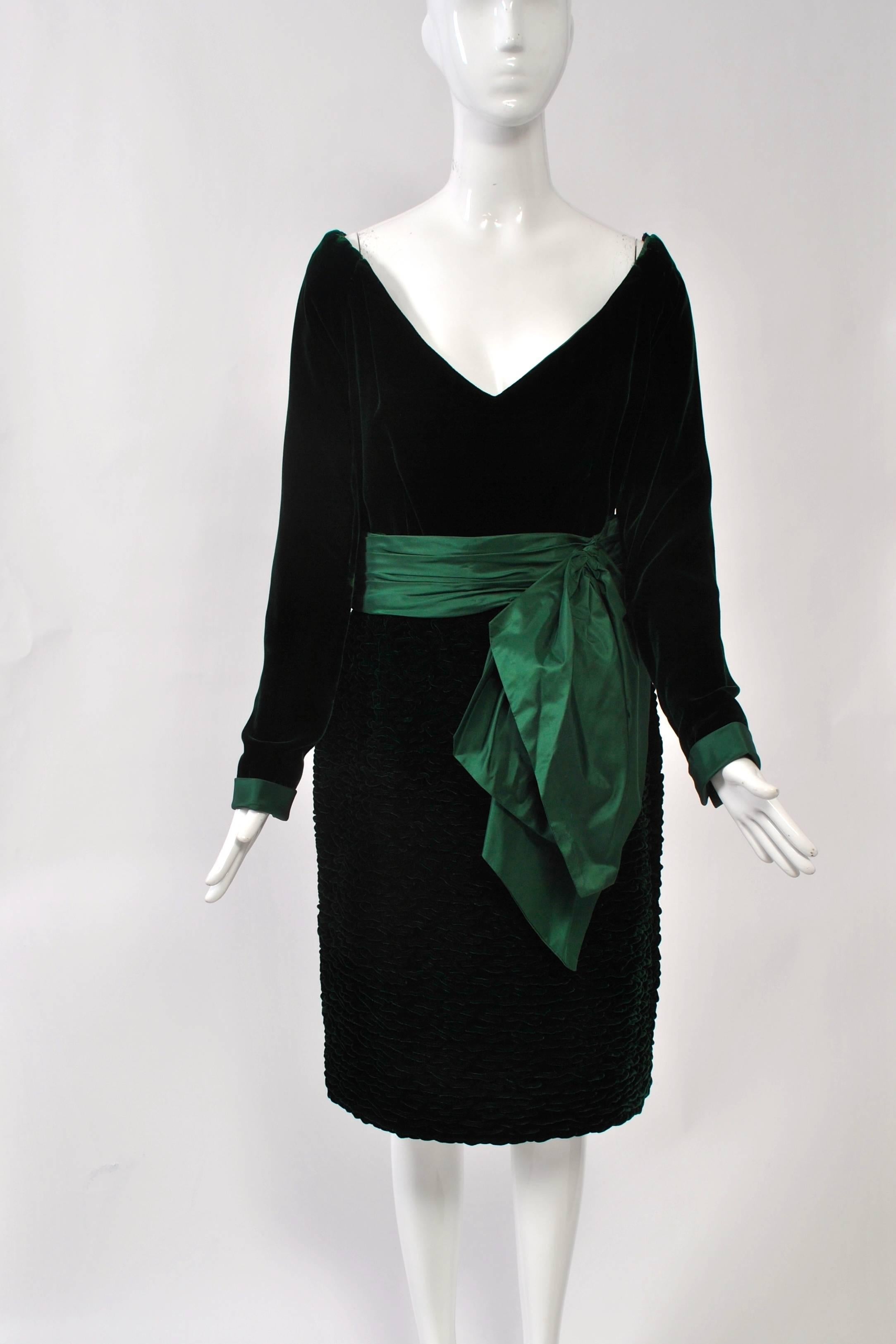 Forest green velvet dress by Oscar de la Renta featuring a deep V, off-the-shoulder neckline and puckered straight skirt. Elastic and lingerie straps help keep the shoulders in place and secure your bra straps. Back zipper. Lined. Size M.