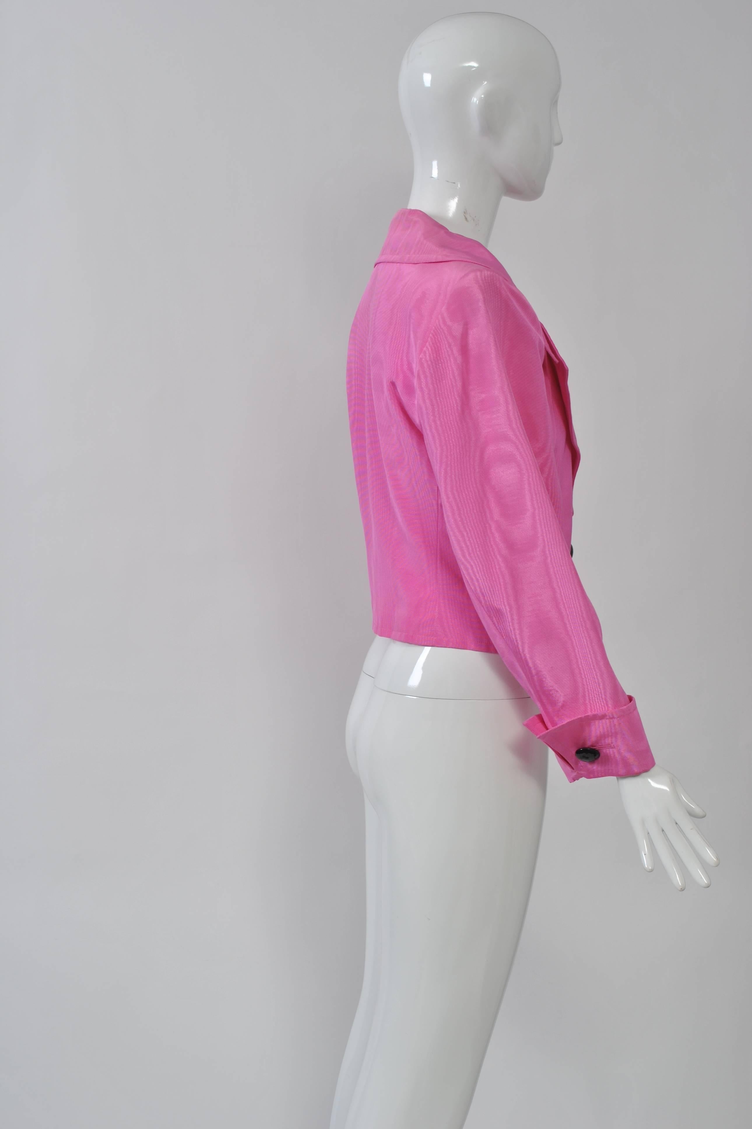 Saint Laurent Rive Gauche short jacket in bright pink moire with a large collar and shaped waist. The turned-back cuffs and single button closure are fastened with large black buttons. Shoulder pads.