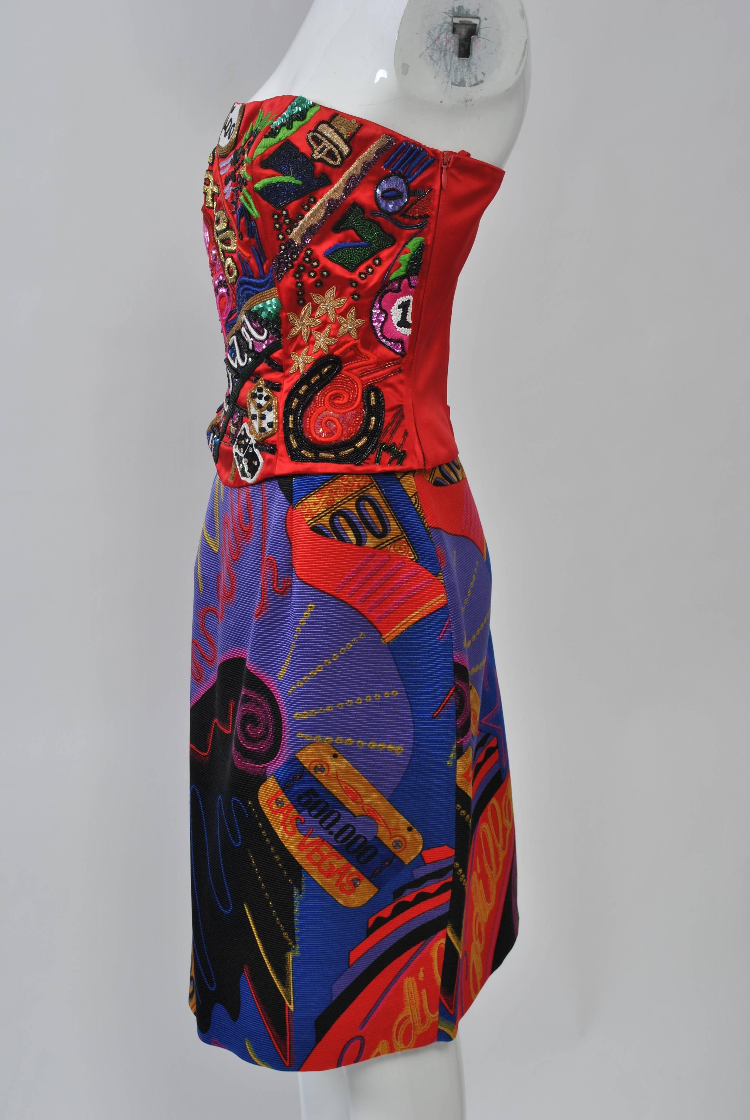 Quintessential 1980s aesthetic defines this outfit from Louis Feraud, its brightly colored print bustier dominated by gambling motifs appliquéd and embroidered on a red satin ground. Accompanied by your choice of two skirts - a coordinating print