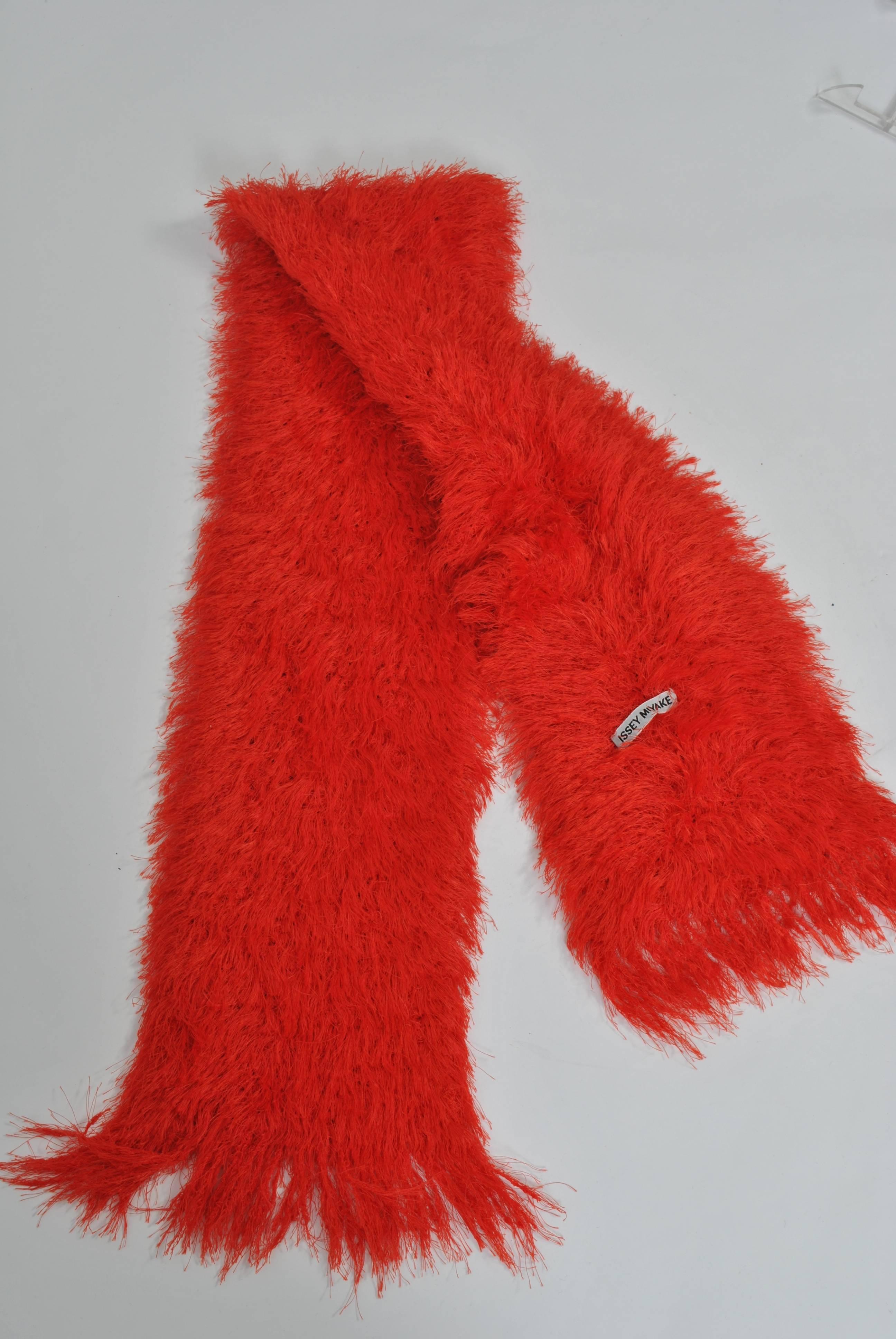 Orange double-faced eyelash scarf by Issey Miyake, rectangular shape, with fringed ends. Add a lively accent to your outfits. A great gift idea.