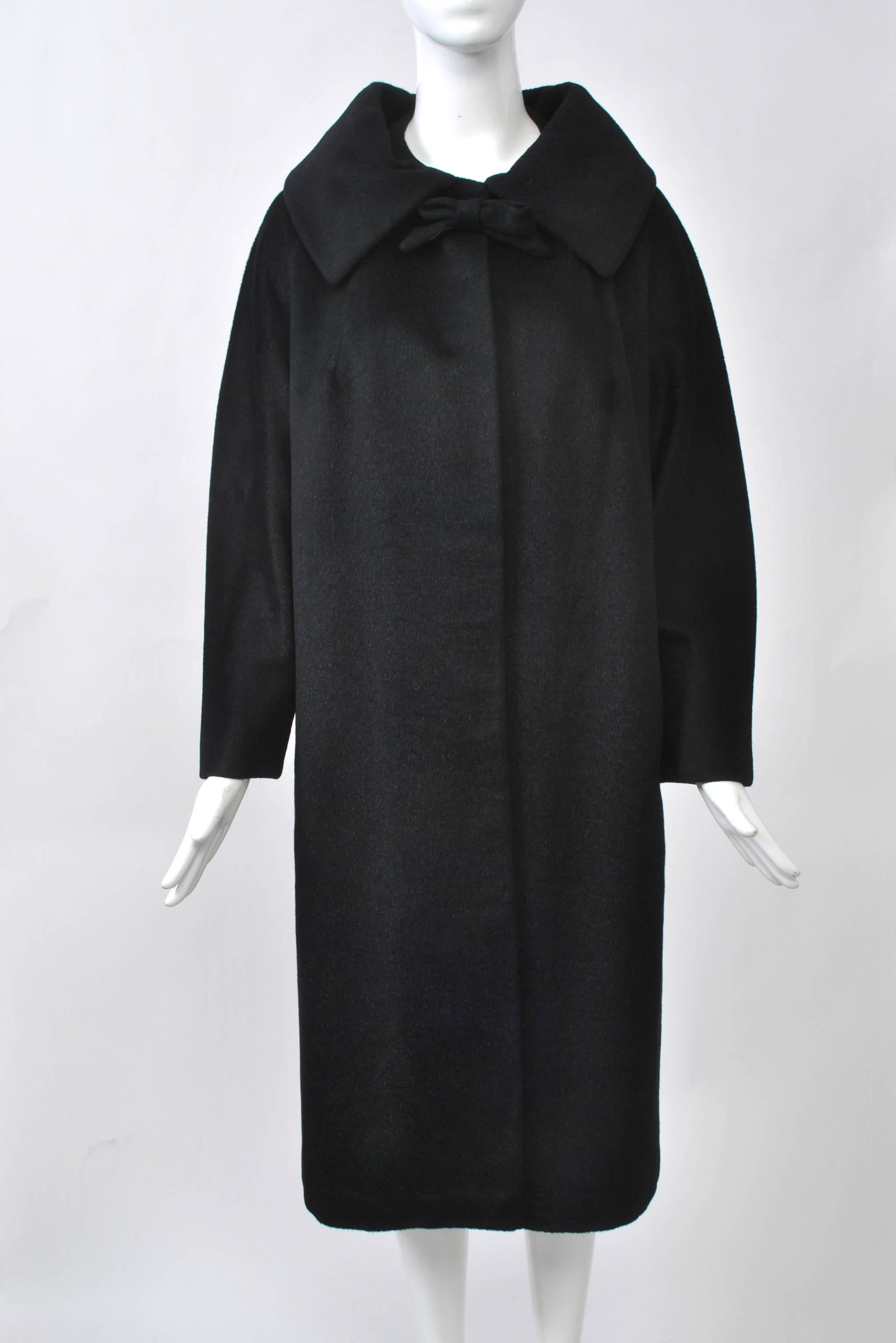 Lilli Ann coat and suits were some of the most stylish produced in America during the mid twentieth century. This example features one of their hallmark fabrics, a Blin & Blin blend with nap and sheen that is smooth to the touch. The coat falls