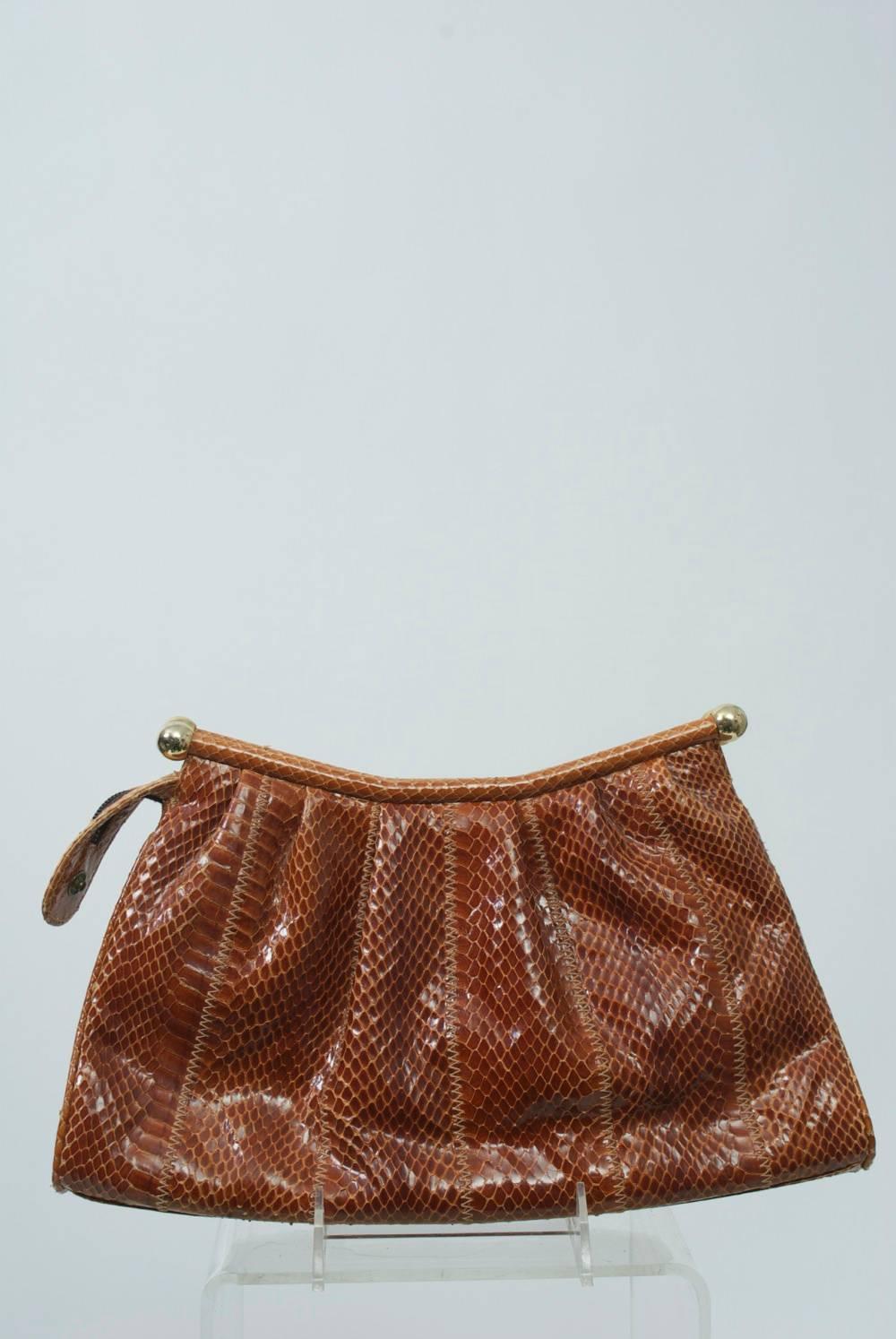 1980s snake clutch by Susan Gail in tobacco features top zipper and attachable long shoulder strap.