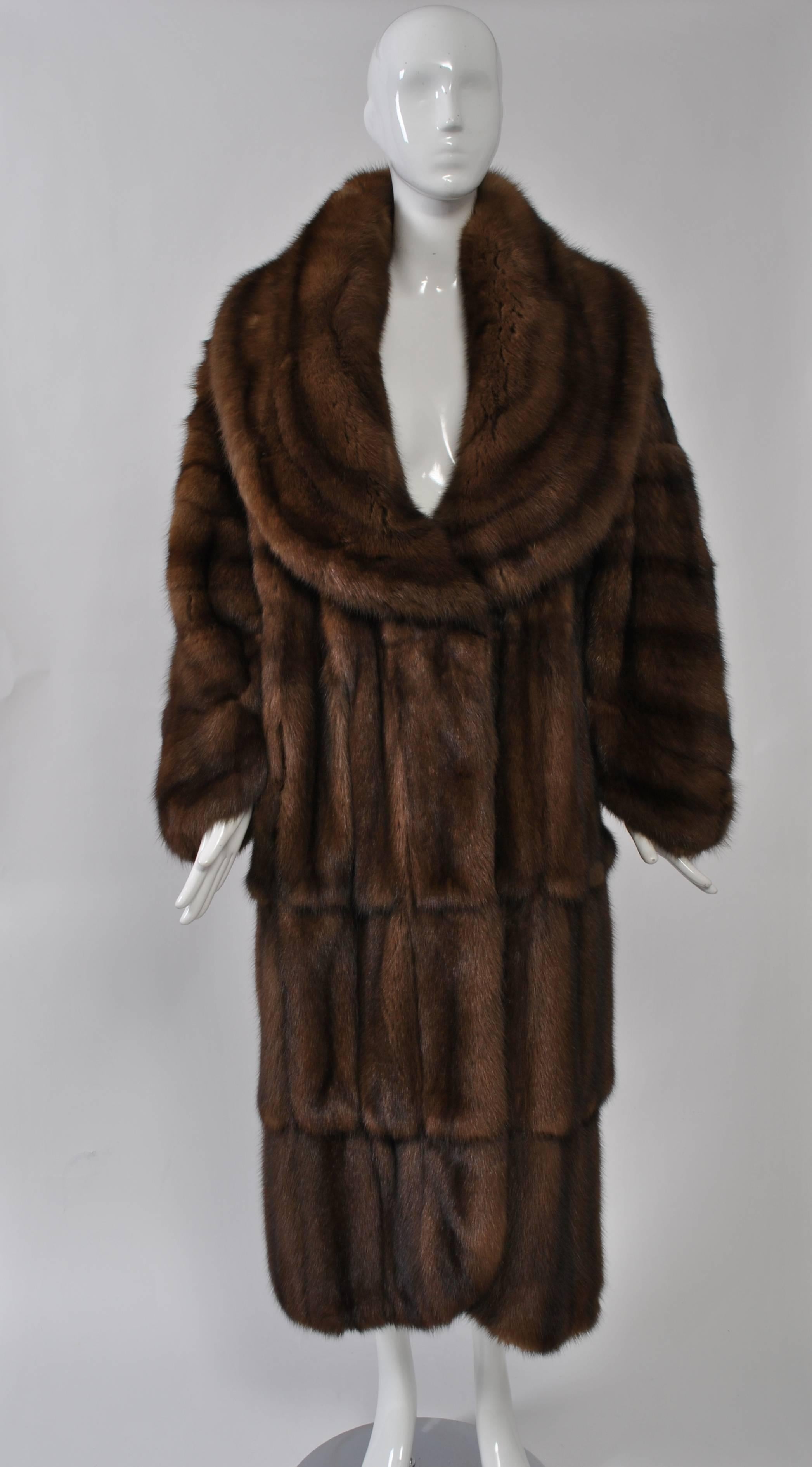 Luxurious, extravagant sable coat by the house of Fendi, whose fur production was overseen since the 1980s by Karl Lagerfeld. Oversized cut with low-cut, huge collar. Skins cut horizontally on top, vertically on bottom, curved front hem and wrists.