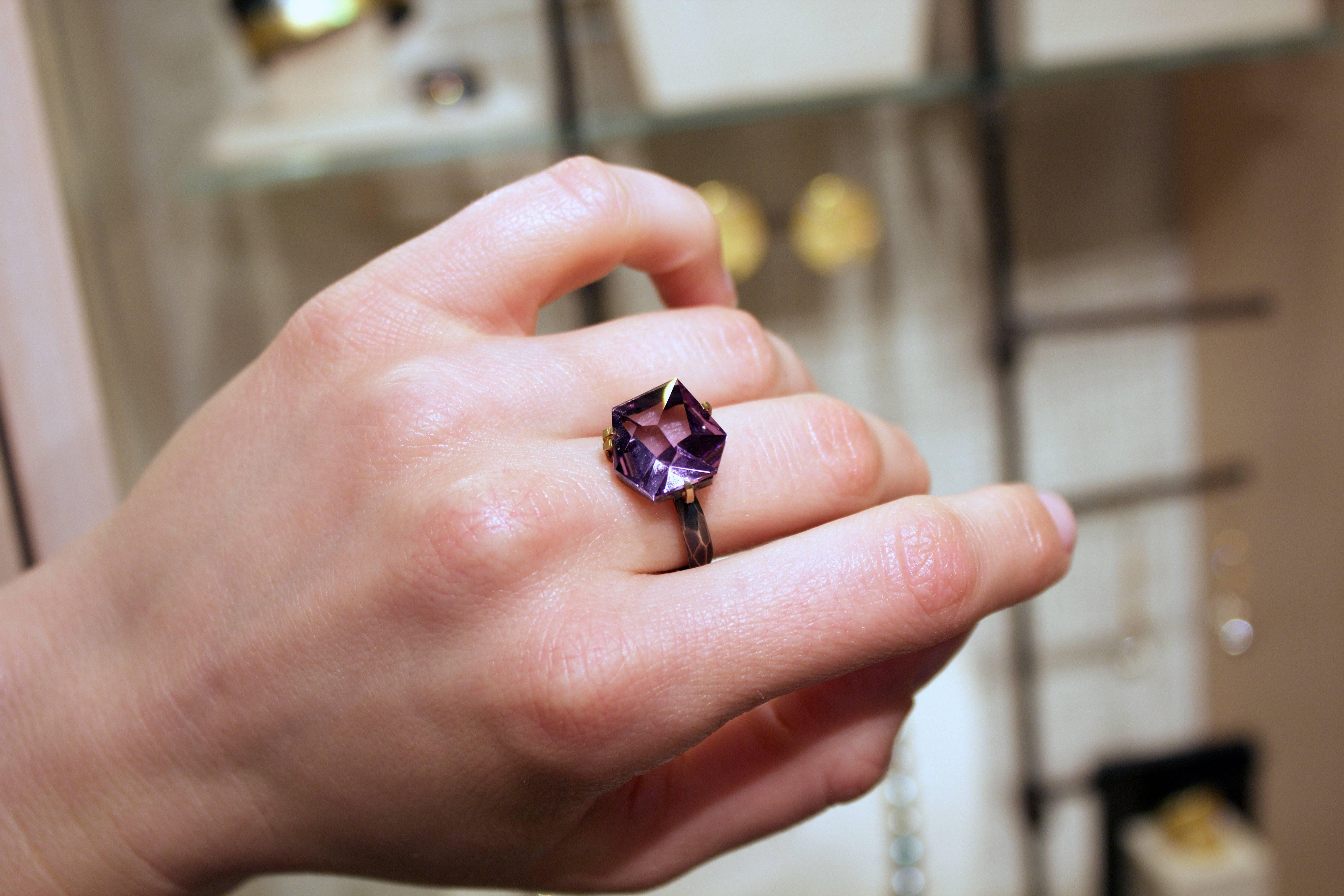 Facets Ring handcrafted by acclaimed jewelry artist Elizabeth Garvin showcasing a spectacular 8.50 carat amethyst custom-cut in Brazilian and set in matte-finished 18k yellow gold single and double bar prongs attached to a hammered oxidized sterling