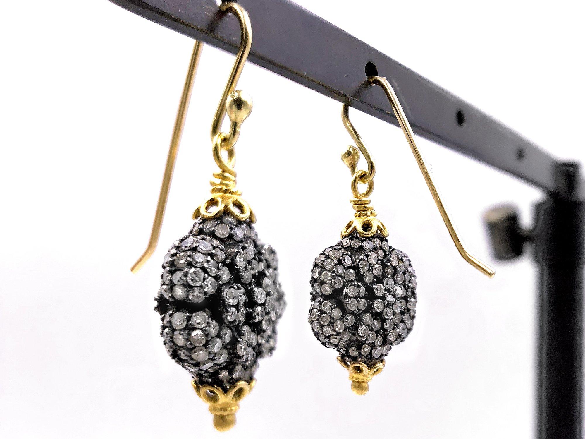Drop Earrings handmade by jewelry designer Fern Freeman featuring shimmering round diamonds set on double-sided black rhodium-finished sterling silver elements wrapped in 22k yellow gold accenting. 