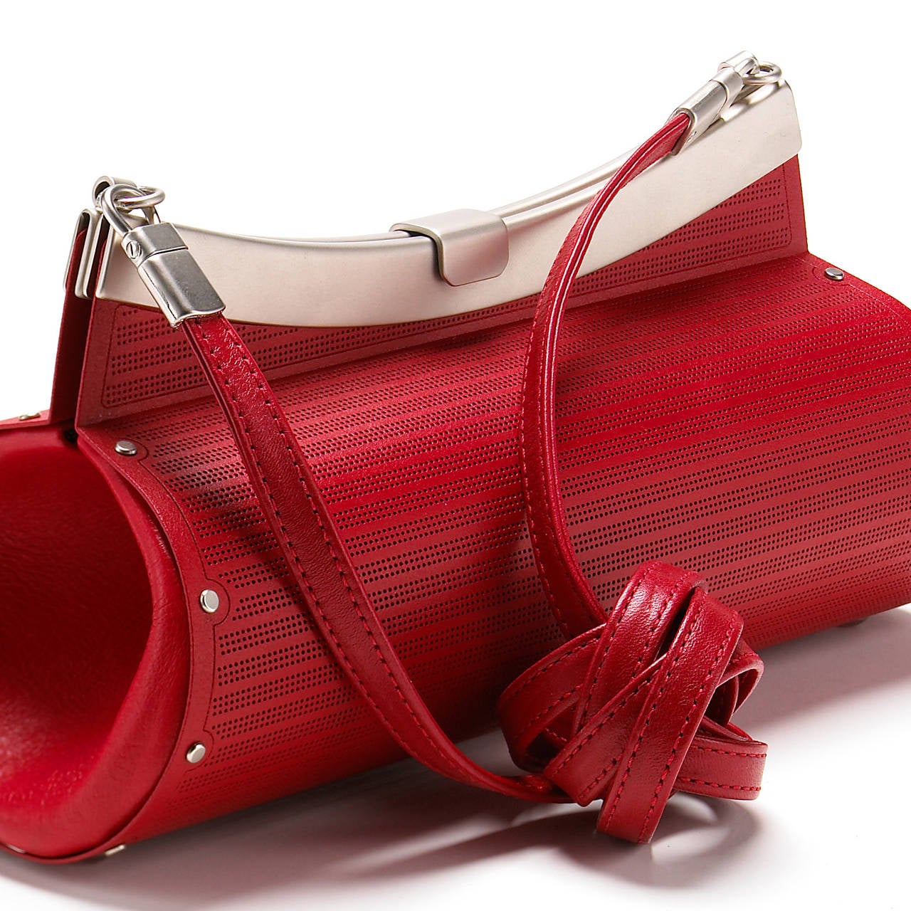 One-of-a-Kind Cylindrical Bag handcrafted in etched and laser-painted red stainless steel with matte satin stainless steel hardware and red leather accents and strap. The purse showcases a detachable leather shoulder strap for versatile wear. Bag