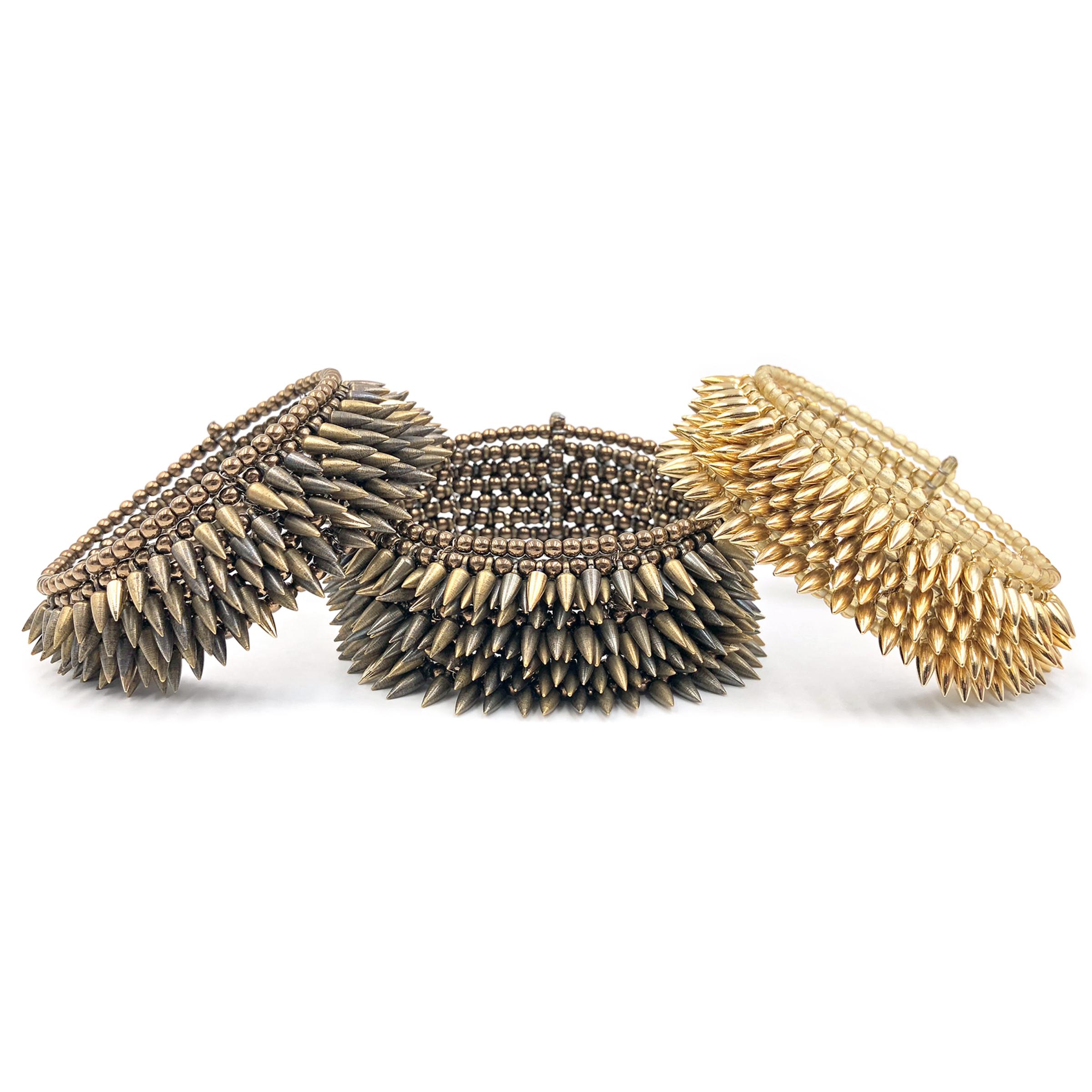 Eight Row Bullet Cuff intricately handcrafted with mixed-tone bullets and bronze glass bead base on gold-filled chain. Spiky yet soft, the 