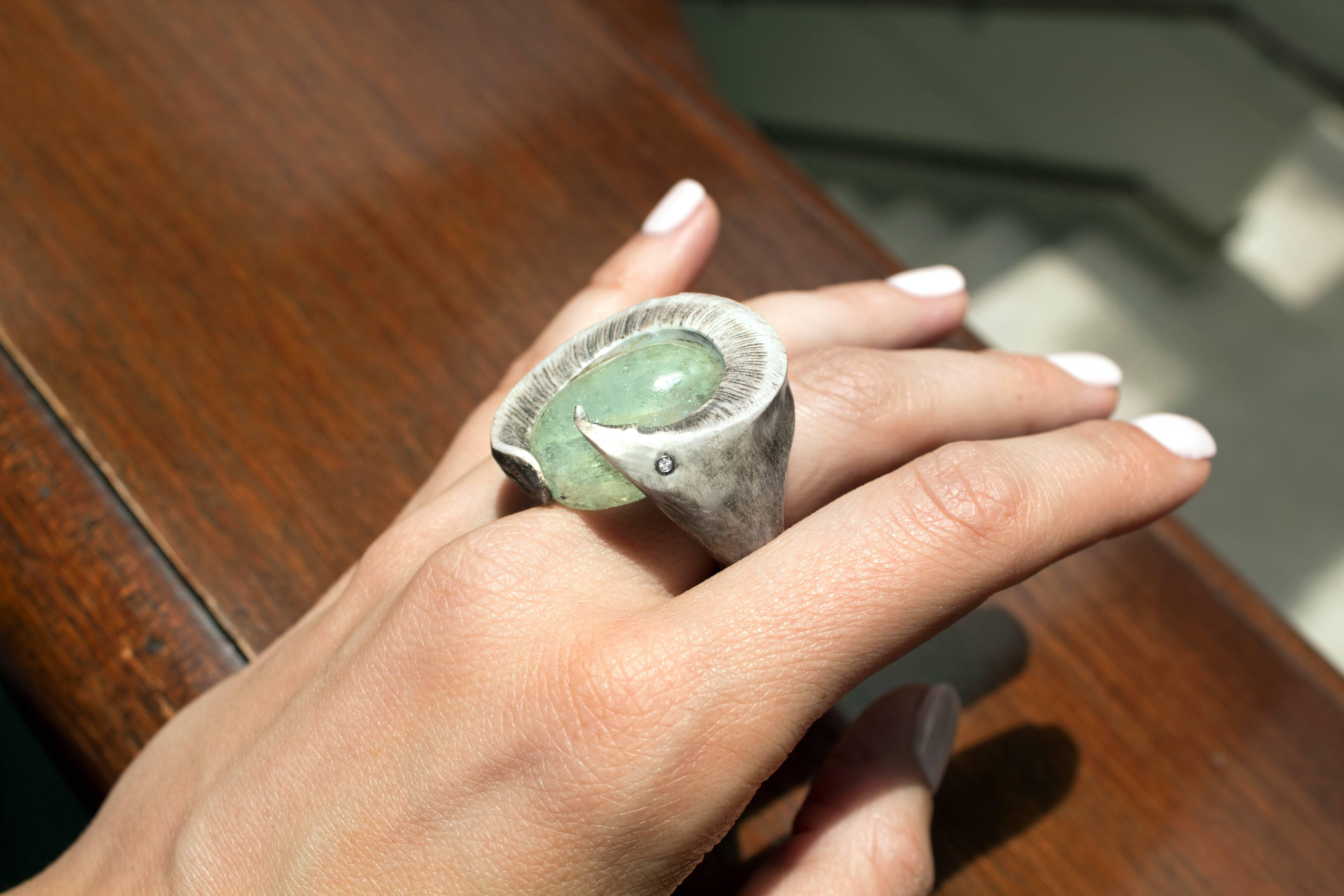 One of a Kind Ancient Aquamarine Ring handmade by artist Susanna Dunne featuring a cabochon-cut aquamarine with rainbow flash bezel-set in faux bone with an embedded white diamond accent in 18k white gold. Size 8.5. 