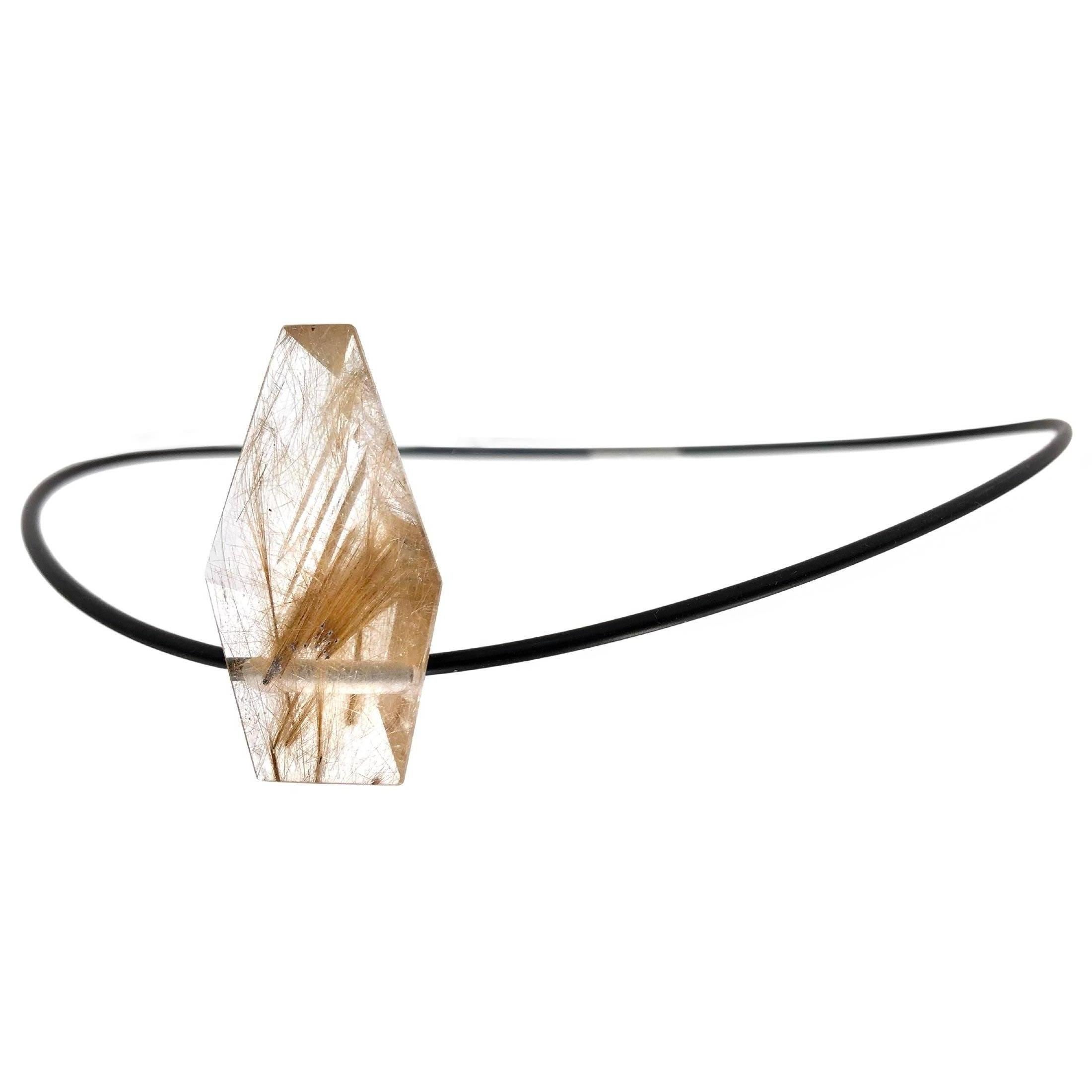 Crazy Horse Necklace featuring a 28.29 carat rutilated quartz hand-cut by master gemstone cutter Atelier Munsteiner on an 18 inch rubber cord with stainless steel bayonet closure. 