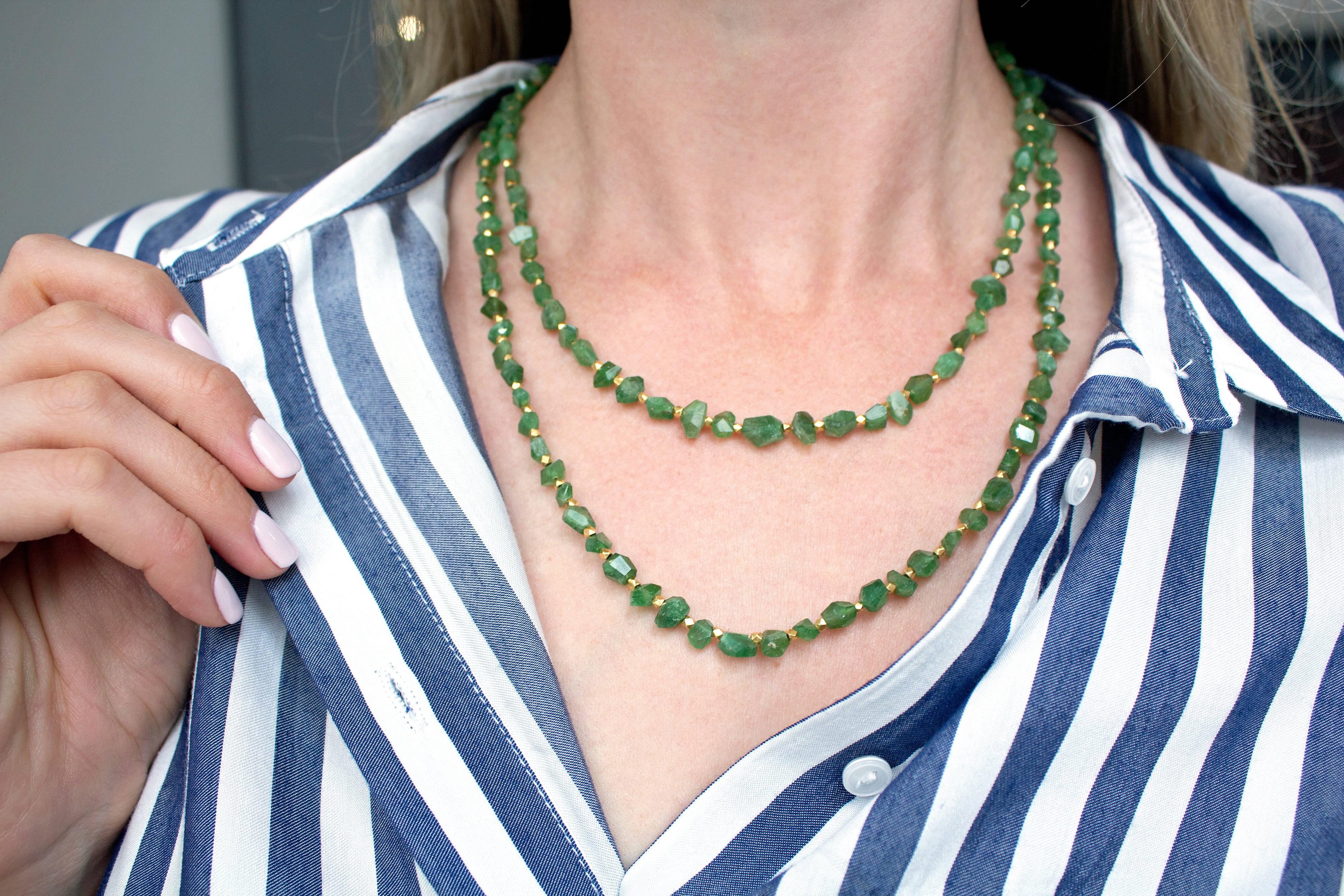 One of a Kind Necklace handcrafted with 165 total carats of faceted green tourmaline beads individually strung between 18k yellow gold faceted spacers and accented with a beaded, ornamental 'S' hook clasp. 41 inches in length.