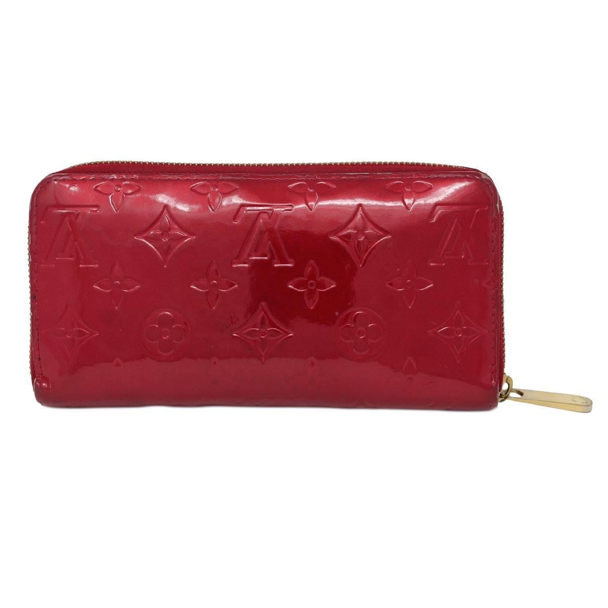 Brand: Louis Vuitton
Style: Zip Around Wallet
Measurements:  7.7 x 3.9 x 0.8
Materials: Red Vernis Leather
Hardware: Golden Brass Zipper
Interior Compartments: Comes with 8 Credit card slots, 1 Zippered Coin Pocket, 2 Large Gusseted Compartments, 2