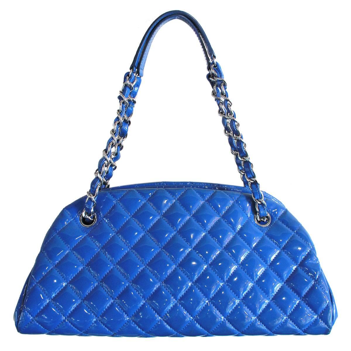 Company: Chanel
Style: Bowler Bag
Handles: Electric Blue Leather Intertwined in Silver Tone Chain Handles; Drop: 7.5