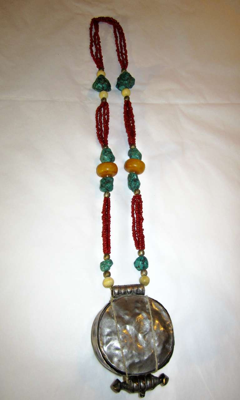 Offered for sale is this handsome antique Tibetan silver gau necklace comprised of turquoise, coral, amber, and bone beads and a silver amulet box or container.  A gau is a Tibetan Buddhist prayer box, usually made of metal and worn as jewelry. 