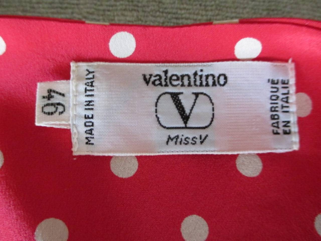 Vintage red silk Valentino from the miss V collection with white polkadots.

we offer more vintage items, view our frontstore

The blouse has two parts at the side for closing, there is a long side zipper.
Size : Italian 46 but fits smaller about