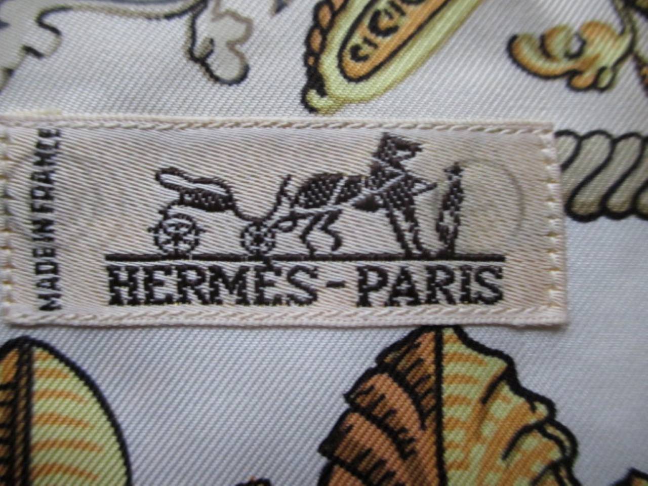 Very rare vintage Hermes silk men shirt with the sun king motive fabric designed by Francois de la Perriere.

Measurements
Length: 80 cm
chest: 90 cm
waist: 90 cm
sleeve: 59 cm
The size is 38 but can fit as 42 EU