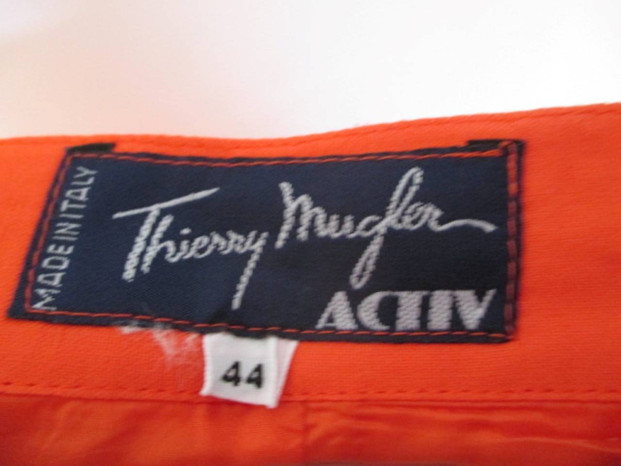 Thierry Mugler 2 piece orange skirt and top with stud buttons and zipper at the back.
The material is half Linen and half viscose.
Size is French 44 but fits like a 38/40
Its in good vintage condition.
The length of the skirt is 45 cm and the top is