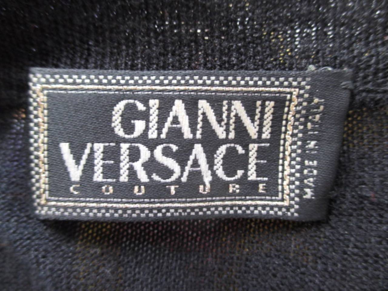 Couture Gianni Versace black sweater is a blend of cashmere, wool and silk with a diamante button (slight damage).
The sweater has detachable shoulderpads.

Size marked 42/11 fits like a eu 40/42 or US 10/12