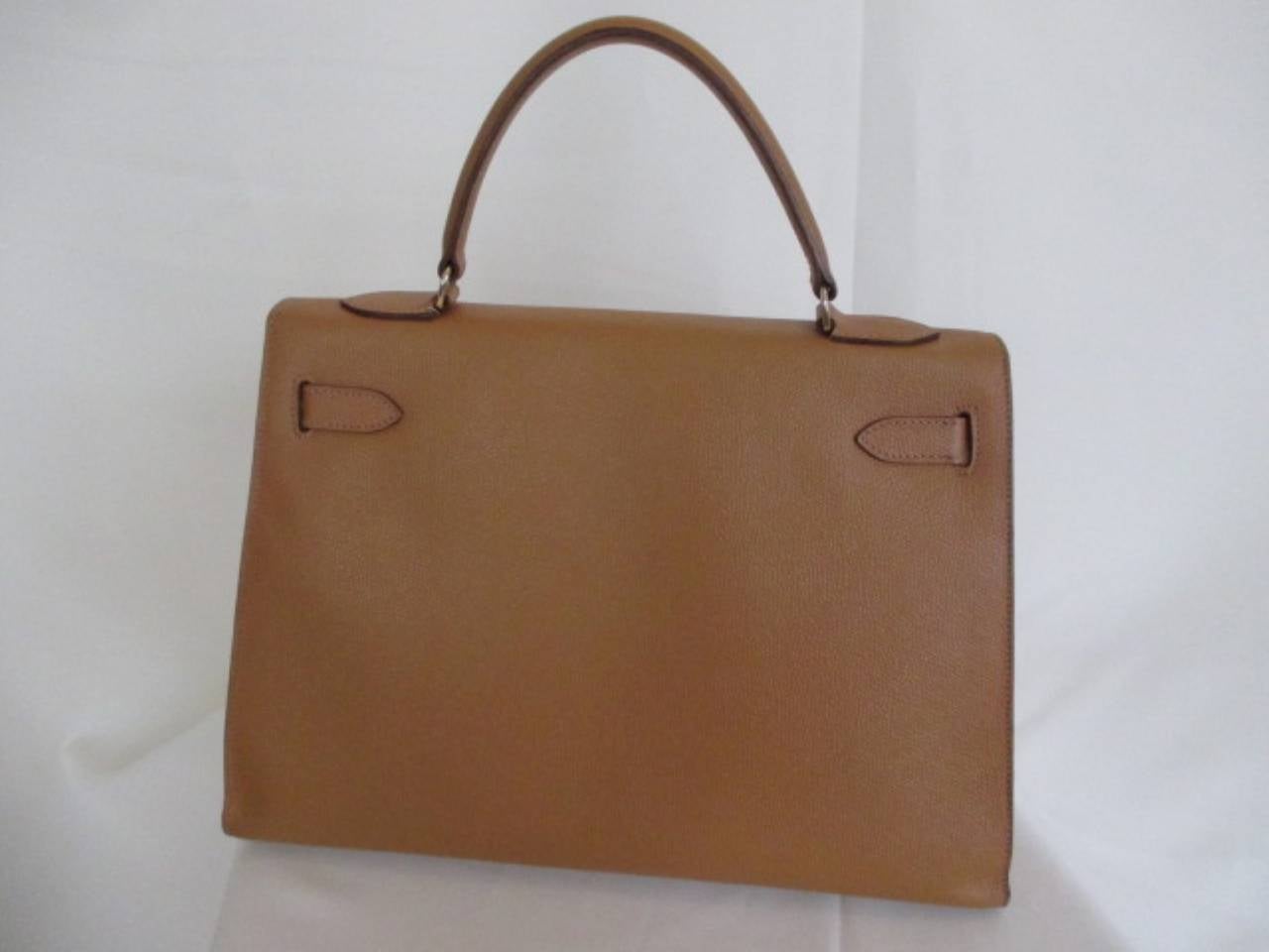 Exceptional classic Kelly bag size 32 cm is the perfect size to take you from day to night or lunch to dinner. 
Has been extremely well cared for.
Interior of soft leather with 3 pockets one of which has a zipper.
This item does not include any