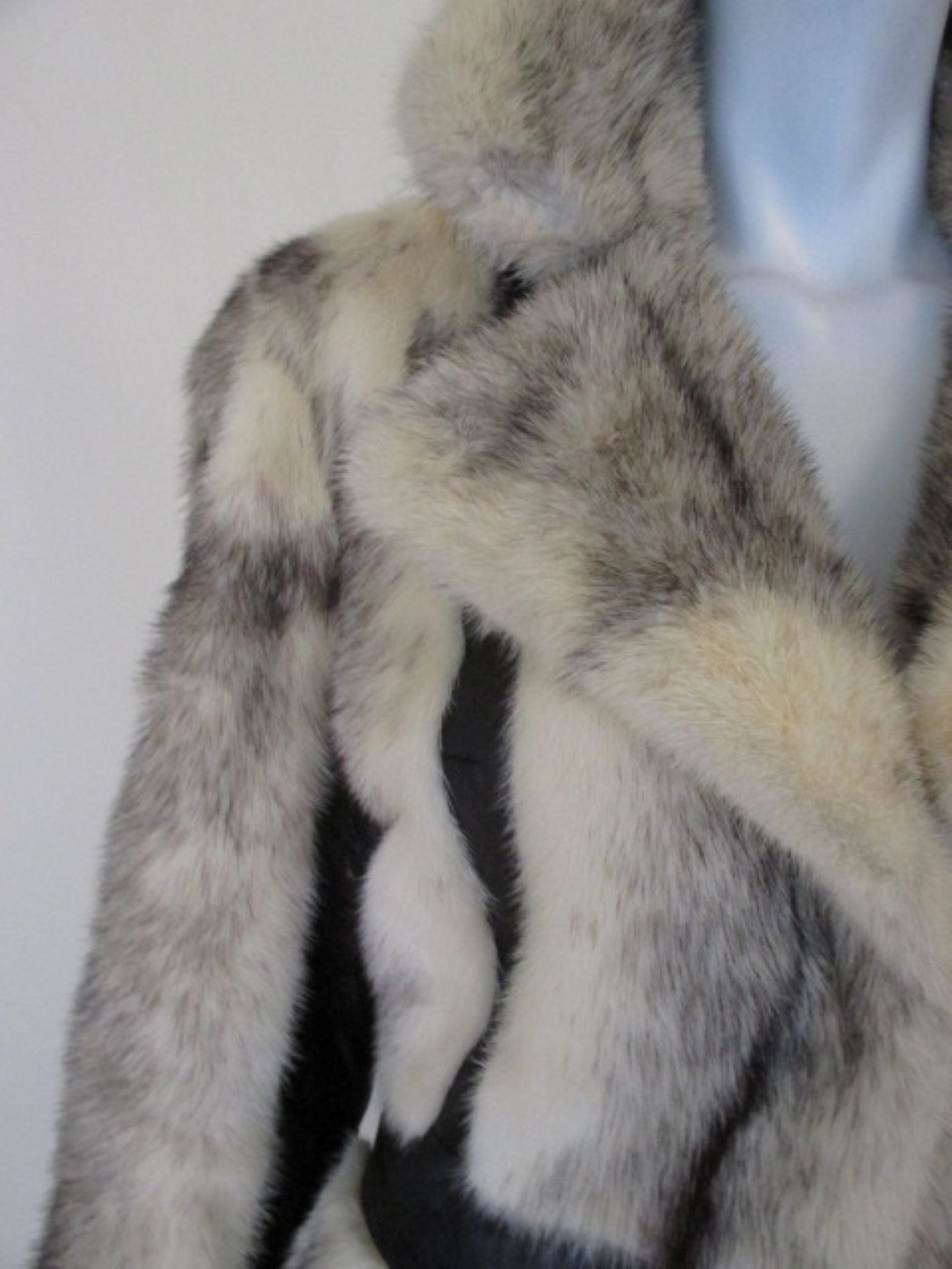 This vintage coat is made of creme color cross mink with black leather details.
The coat has 2 hooks an inside pocket and is from New Haven, Connecticut.
Former owner of the coat is Peggy K.(see photo)
The coat has 2 black leather line exterior
