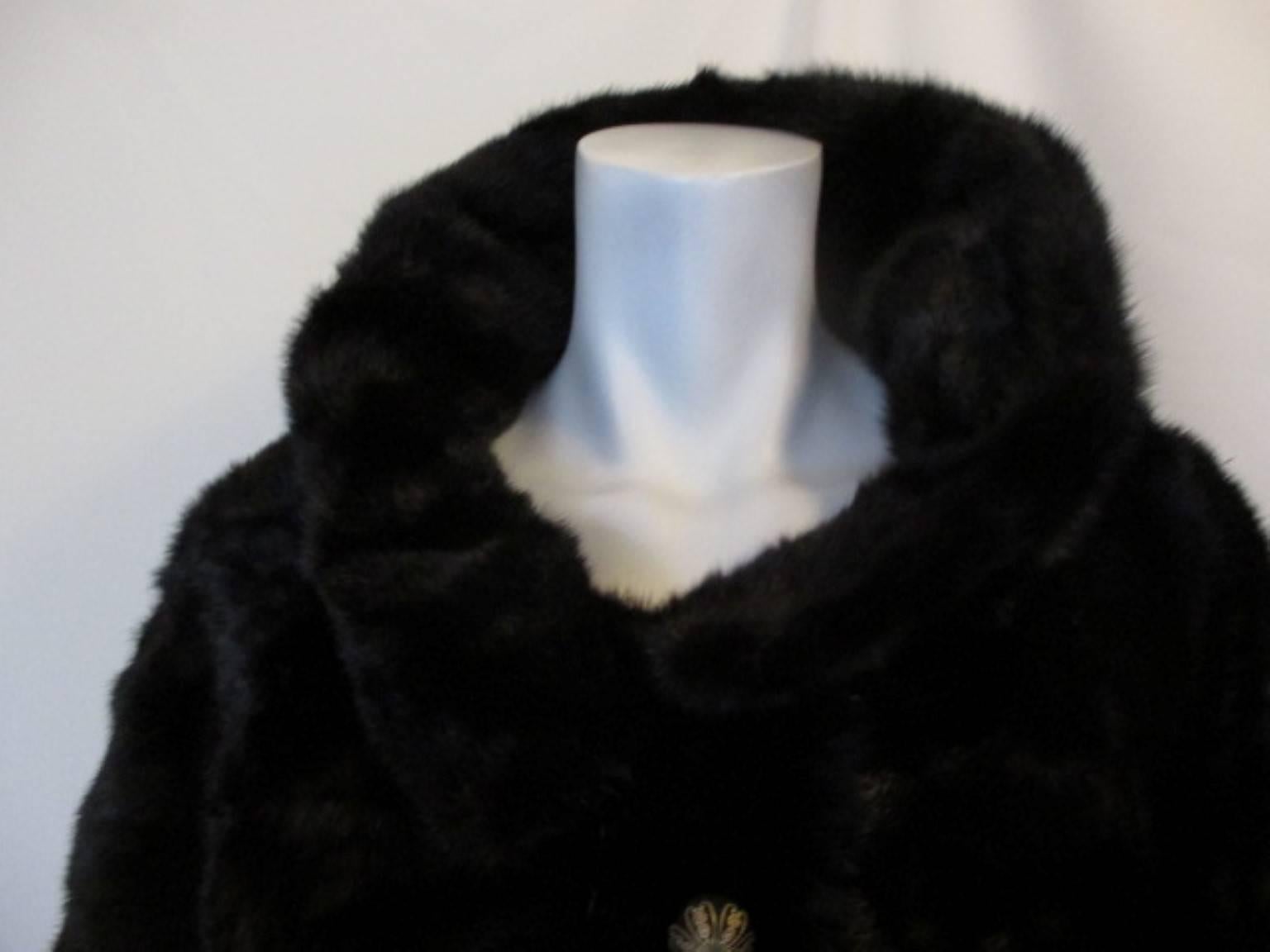 This Neiman- Marcus black mink has 2 pockets, 1 closing hook at the collar and 4 decorative buttons.

We offer more exclusive fur items, view our frontstore

It has a number issued by the fur label authorithy, Y460607 and it is monogrammed, see