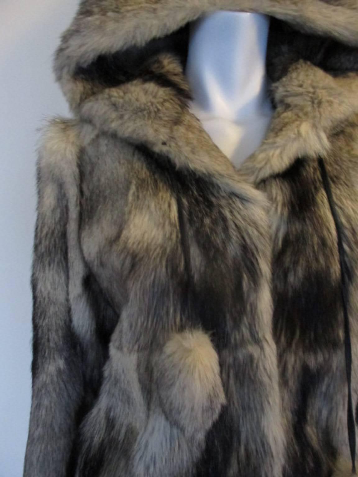 This coat is simply exquisite & super glam. In prestige vintage condition. Well looked after. This coat is extremely rare and one of a kind.
The hood closes with draw strings tipped with wolf tail.

The coat is made in Germany, Echt Pelz