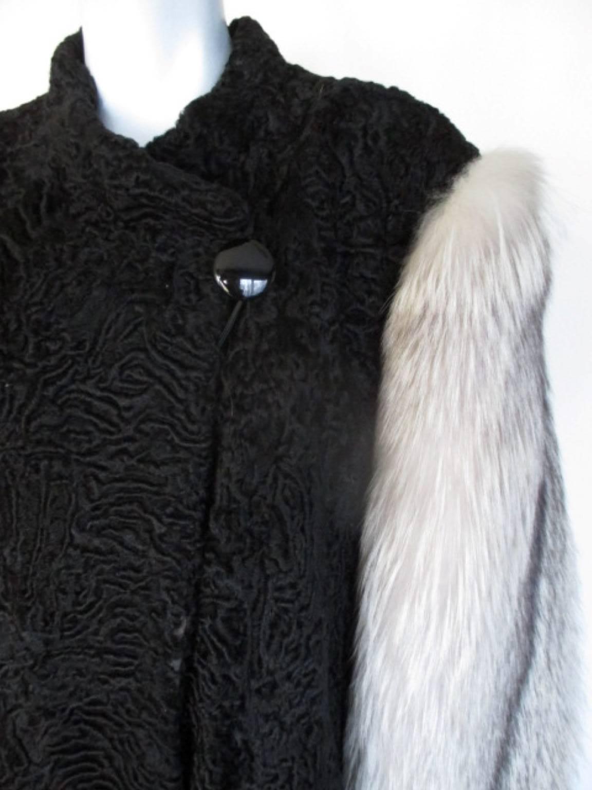 Black persian lamb with artic fox fur sleeves.

We offer more Persian lamb fur items, view our frontstore.

Details:
This vintage coat in Art-Deco style has 1 closing button, 4 closing hooks and 2 outside pockets.
Its in good pre-owned condition