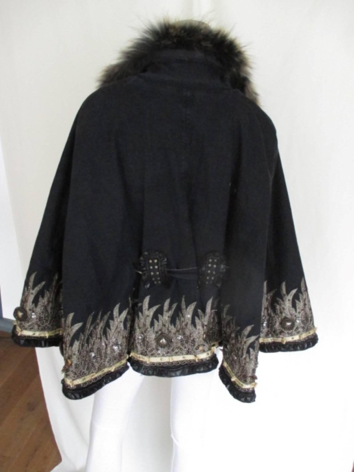This cape is designed by Cobayashi.
Material outside is 98% cotton/ 2% elasthane,
Inside is soft material 60% polyester/ 40% acryl, which keep you warm.
Its embroidered with stones and gold color fabric.
The collar is made of fox fur.
Belt is on 1