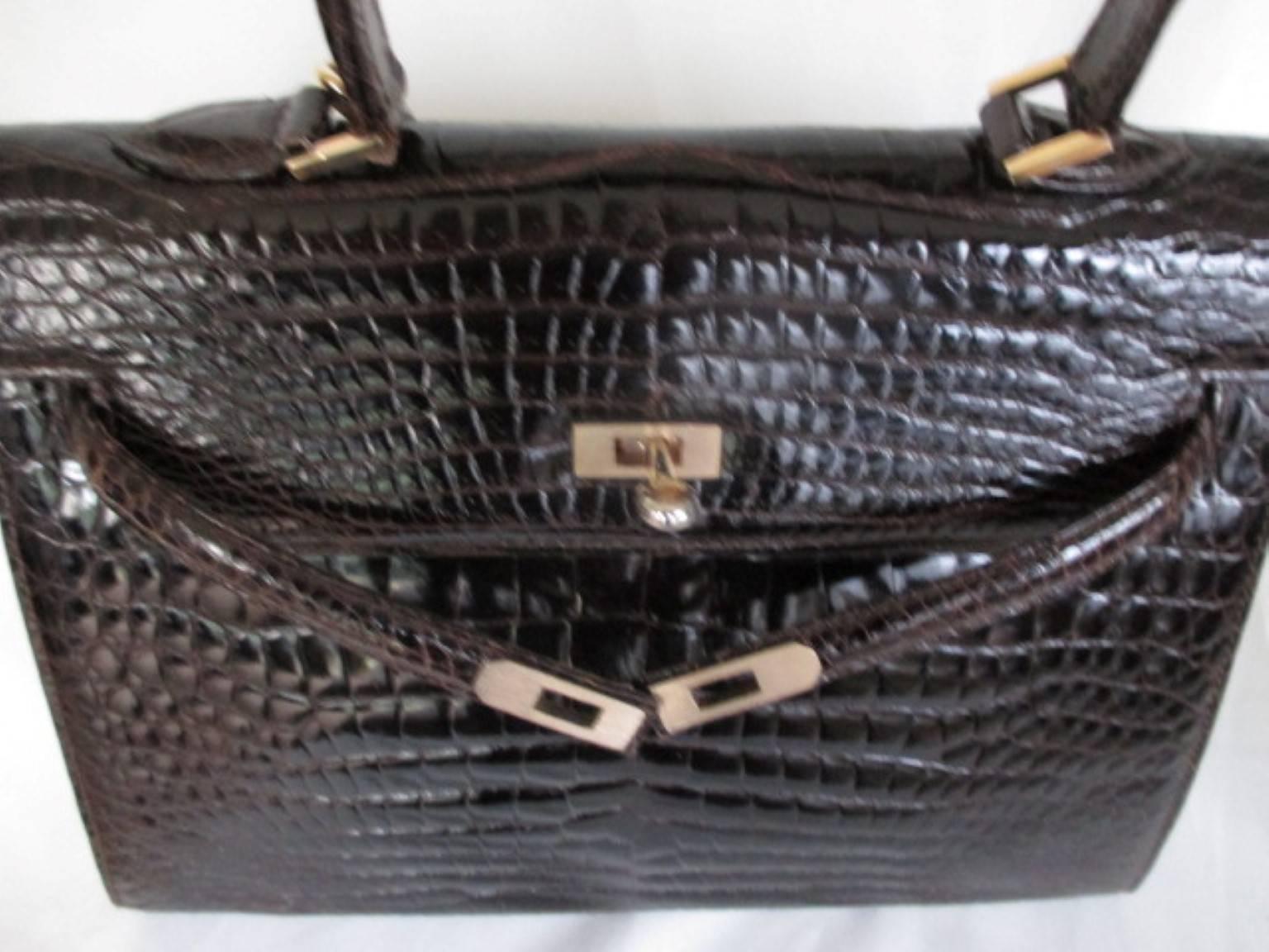 Exquisite rare vintage kelly style handbag made of quality crocodile leather with gold hardware.
It's in preloved vintage condition and comes only with a lock (no key).
Inside is leather with 1 zipper pocket and 1 open pocket.
Slight signs of