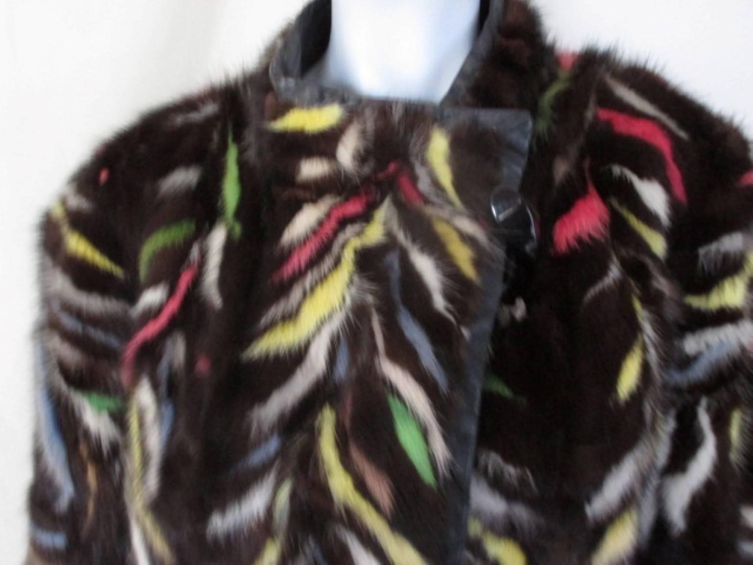 This vintage coat is made of dyed mink with trimmed black leather at sleeves , pockets and inside.

We offer more exclusive fur items, see our frontstore.

Details:
With wide sleeves, 2 pockets, 2 closing buttons and 1 inside button.
 Good pre-loved