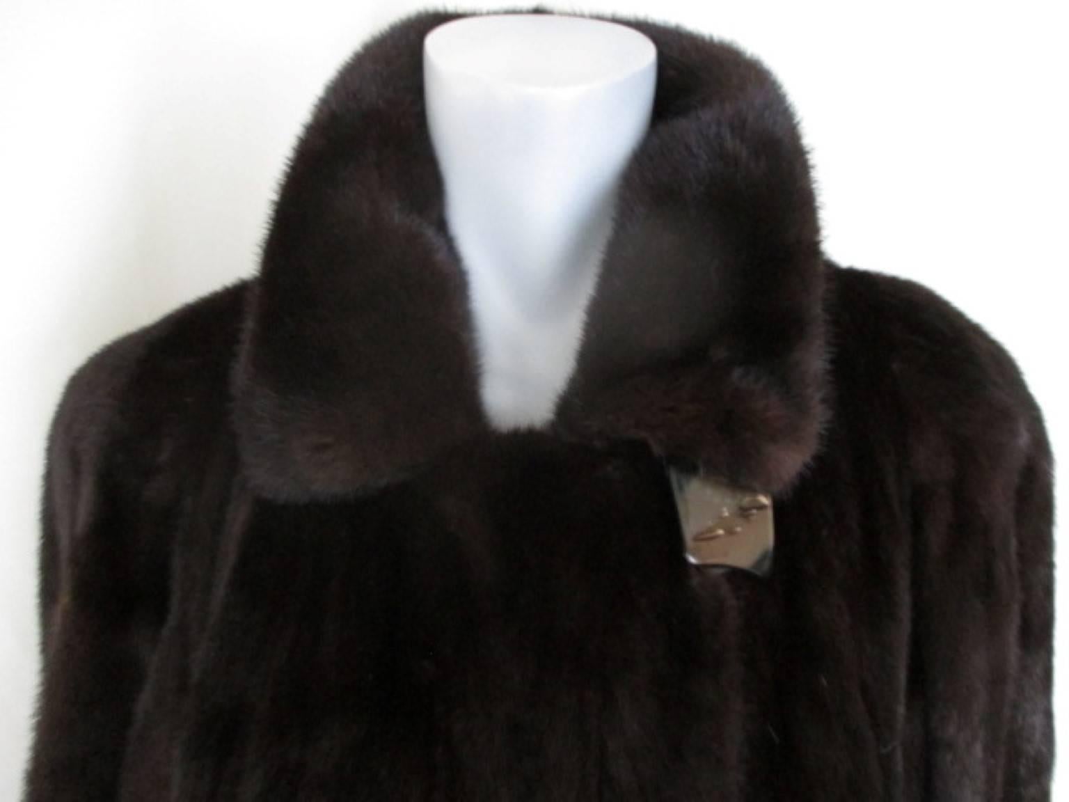 This dark brown coat is made of top quality mink in Canada.

We offer more exclusive fur items, see our frontstore.

Details:
It has 2 pockets, 1 inside pocket, 1 closing button at the collar and 4 closing hooks.
Furrier:  by the furrier house