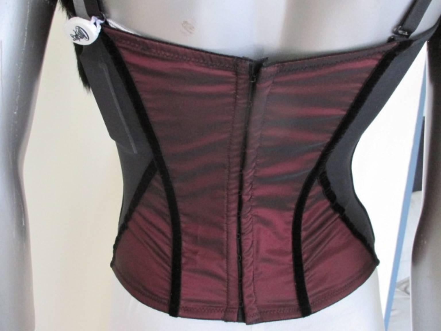 This bustier is new and never worn it has still the tags from the exclusive Italian designer lingerie brand Christies.
The color is black / bordeaux with black fur and rhinestones, the fur is
detachable and the body has velvet details.

Size
