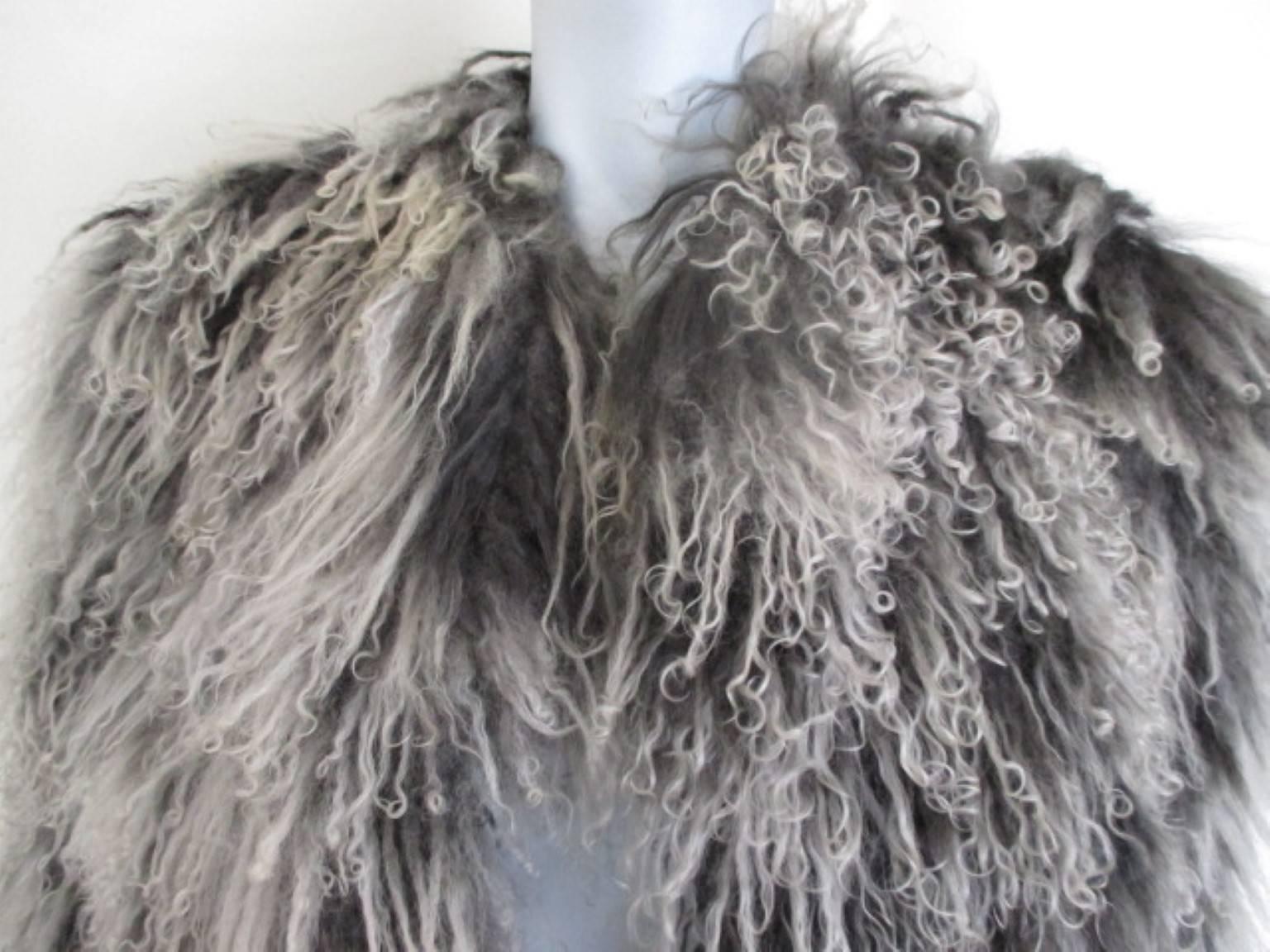 This grey/ black mongolian lamb fur is good quality lamb,  very soft and easy to wear.
It has 2 pockets, 3 closing hooks and an inside pocket, designed by Ivonne difussion.
Its in excellent condition.
Size fits medium to large (see section