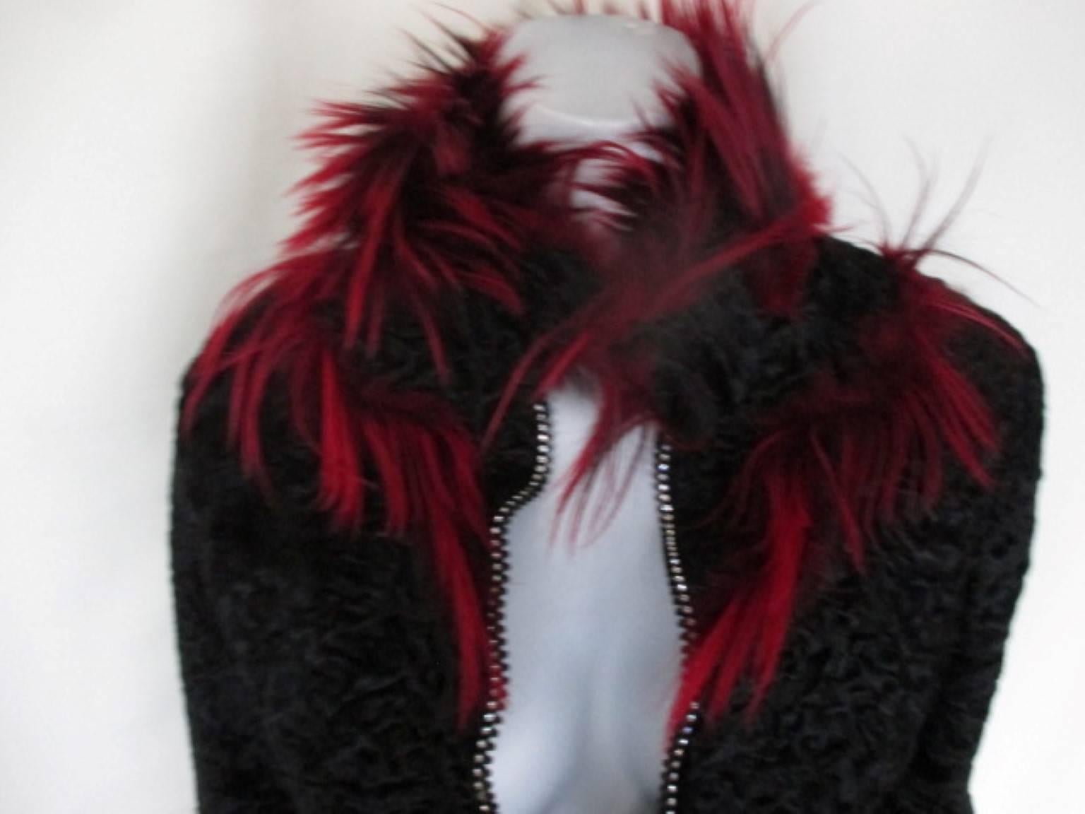 This vintage Italian design jacket is made of black persian lamb and trimmed with dyed red fur.

We offer more vintage fur items, view ur frontstore

Details:
Closes with a zipper which is trimmed with rhinestones.
No pockets. fully lined.
Appears
