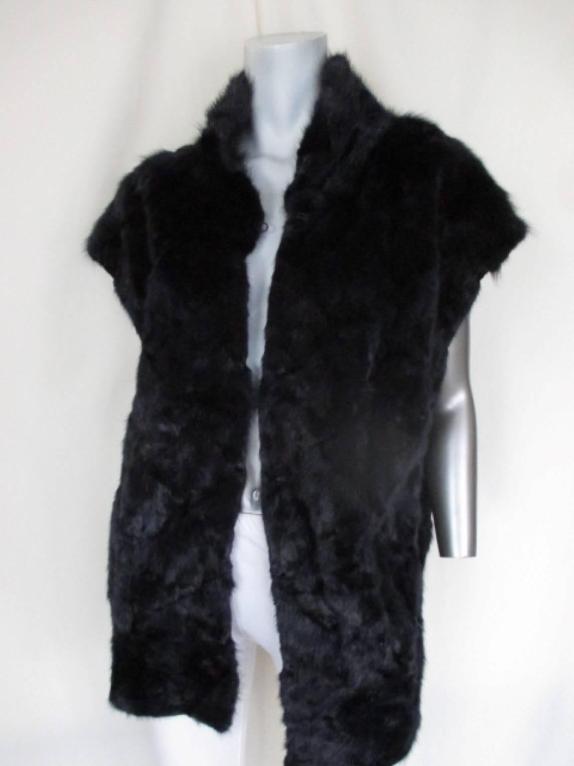 This vest is made of fabric print and dyed purple /blue mink fur 
Its reversible
It has 3 closing hooks, 2 leather pockets
In good vintage condition 
Size fits about medium /large
