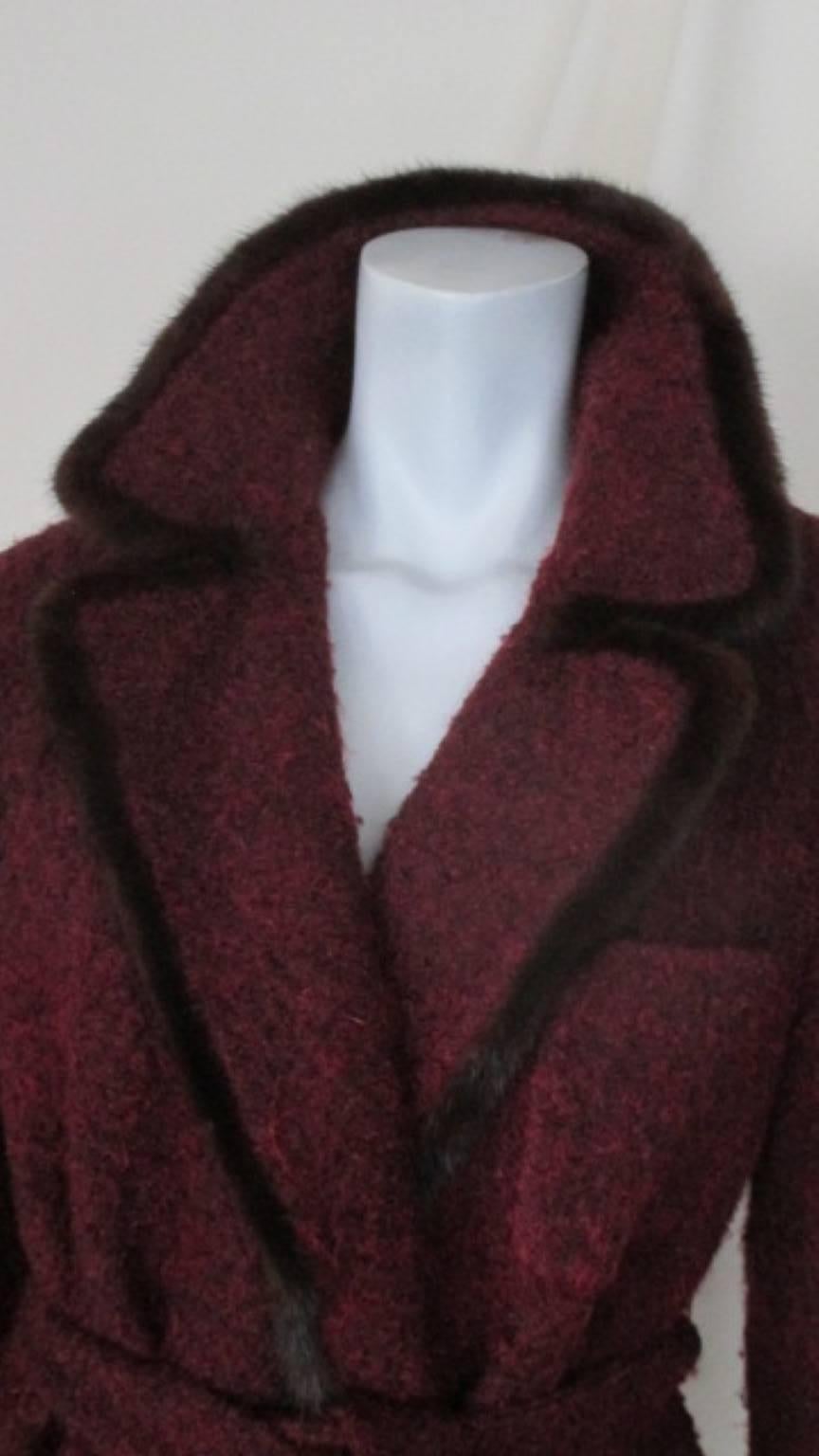 This wool coat is made by Etro Milano, Italy

Trimmed with brown mink fur has 2 pockets and a belt , no buttons
Pre owned condition.
Appears to be EU Italian 46 which is US 12 /  EU 42, please refer to the measurements in the description.

Please