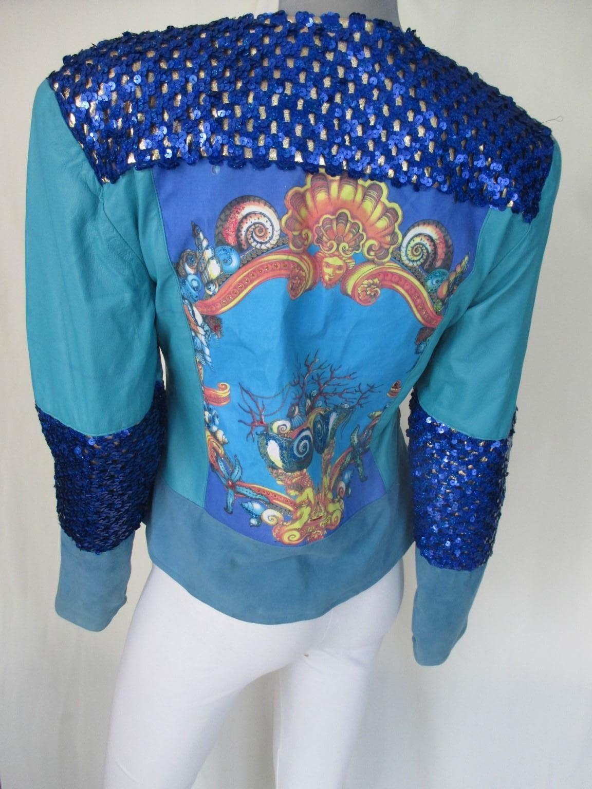Unique 1980's turquoise soft leather jacket with embroided details and a print at the center back
Sleeves with sequines, leather and suede, no pockets with shoulder pads
Good vintage condition a few spots on the leather, see pictures
Designer: Petra