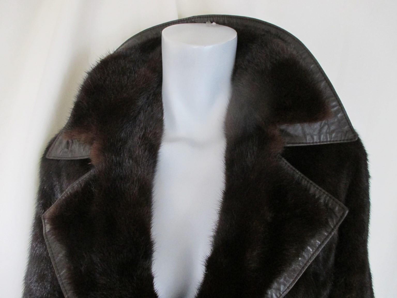 This vintage coat is made of brown mink fur with brown leather side panels and a leather belt.
The coat has 2 closing hooks and 2 pockets.
Furrier:  Regina pelze, Germany
Its in fair vintage condition with some wear at the lining
Size is