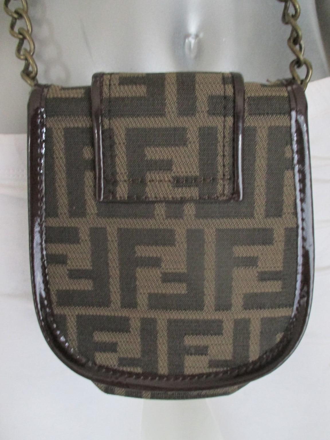 Vintage 1990 Fendi small cross body bag -collectors item- for your phone and/or lipstick
Color and material: brown patent leather with fendi logo fabric
Gold tone hardware logo
Condition is fair with minor wear at the patent leather