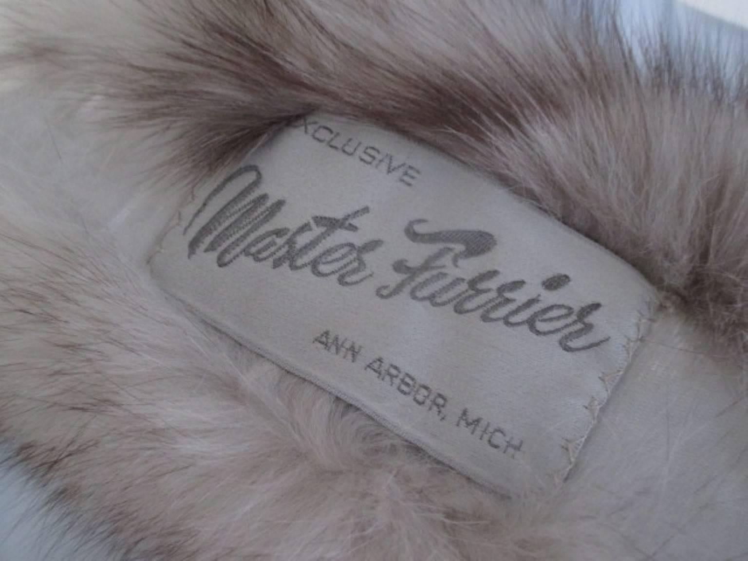 Arctic vintage fox fur stole with 2 fox tails.
The inside is lined with velvet.
From : Exclusive Master furrier, Ann Arbor, Michigan.
Please note that vintage items are not new and therefore might have minor imperfections. 
