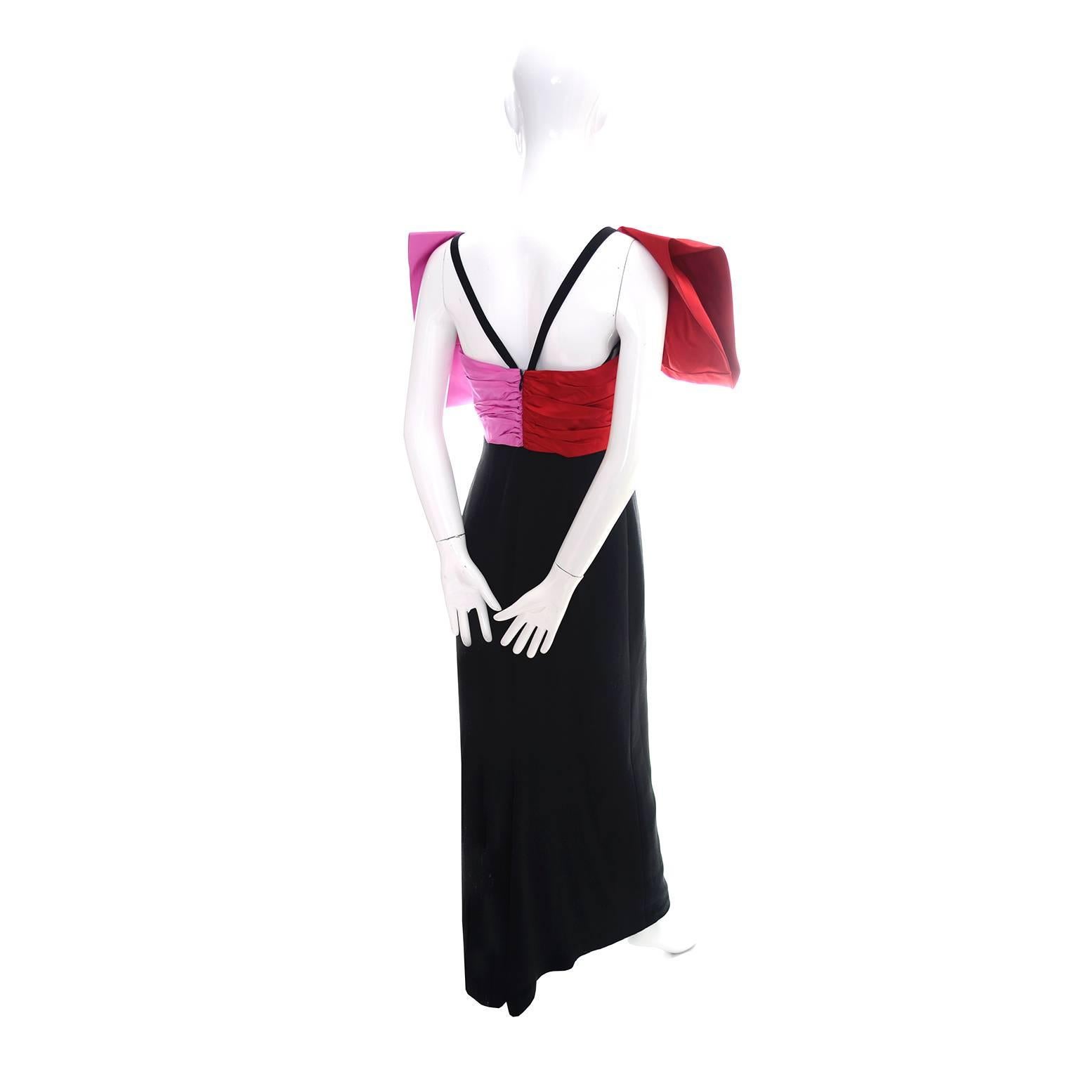 This is an outstanding vintage dress from Bill Blass that definitely makes a statement with its beautiful pink and red oversized bow.  The slim fitted black crepe dress is figure flattering and closes with a back zipper.  The built in corset with