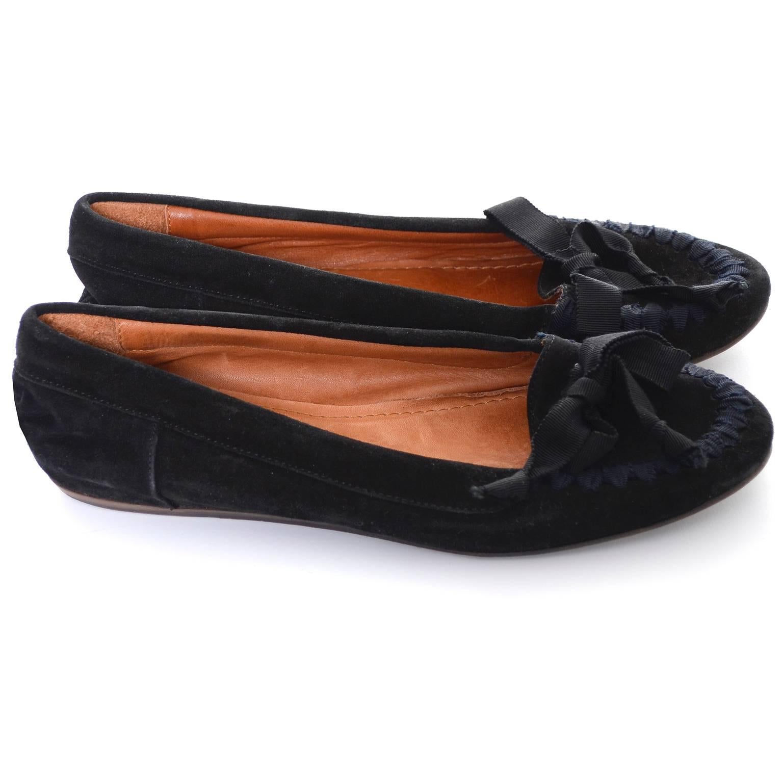 Pretty Lanvin Paris black flat loafers with grosgrain ribbons and bows.  These black suede shoes are labeled a French size 38 with is a US size 6 and 1/2.  The shoes have minor sole scuffs but are otherwise in excellent condition. Made in France.